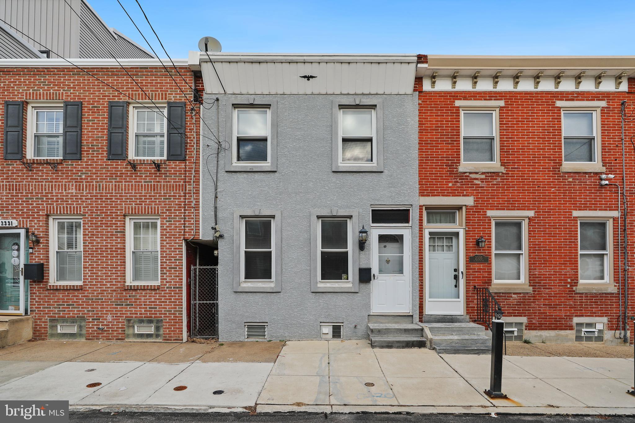 Welcome home to 2333 East Boston Street! This charming 2 bedroom, 1.5 bath is located on a quiet street in the highly desirable neighborhood of Fishtown.  Upon entering the house you are welcomed by a gorgeous exposed brick wall the runs the entire length of the living and potential formal dining space.  Fresh paint, recessed lighting, and natural hardwood floors run throughout the house including into the newly updated kitchen.  The kitchen boasts numerous upgrades such as all new butcher block countertops, subway tile backsplash, sink, an electric range and hood, and a new ceiling fan.  Natural sunlight is abundant especially within the eat-in kitchen at the back of the house.  Off of the kitchen is a nice sized patio which is perfect for gatherings and BBQs.  A gated alleyway provides easy access to the backyard.  Two stylish black spiral staircases run to the two additional levels within the house.  Downstairs you will find an oversized partially finished basement which can be used for an extra hangout space, small in-home gym, or an office.  A half bath is tastefully tucked away along with ample storage and closet space.  Washer and dryer are included with the house along with a ready to be customized laundry shoot! Upstairs you will find a massive primary bedroom with a closet, recessed lighting, and a new ceiling fan/  A second bedroom is in the back of the house with more recessed lighting and a closet.  The full bathroom sits between the two bedrooms and has a tub/shower combination.  The house is in walking distance to anything and everything that you might need from grocery stores (Riverwards Produce Market), gyms, coffee shops (Coffee House 2, Forin Café), favorite Fishtown restaurants (LMNO, Kalaya, Suraya), bars, and breweries.  Make an appointment today; this house will not last long!