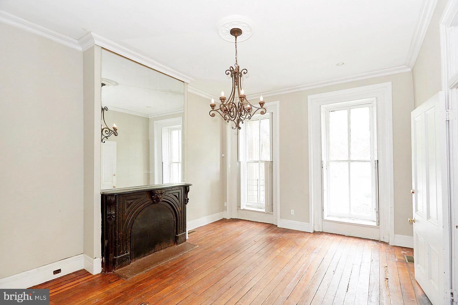 More pictures coming soon! Welcome to this expansive, park-front historic gem in the heart of the Franklin Square community. Renovated between 2016 and 2017, this grand property was converted from a three-unit building into a massive, 3,000+ square foot single-family home. The front parlor makes a stunning first impression with extraordinary 12-foot ceilings, an original slate fireplace mantle, and tall windows framed by classic built-in wood shutters. Lovingly refinished original wood floors flow throughout, adding timeless warmth and character. Designed with functionality and privacy in mind, each of the upper floors hosts 3 bedrooms and 2 full bathrooms (6 bedrooms and 4 full bathrooms total). Enjoy majestic park views and endless possibilities in this grand Baltimore rowhome.