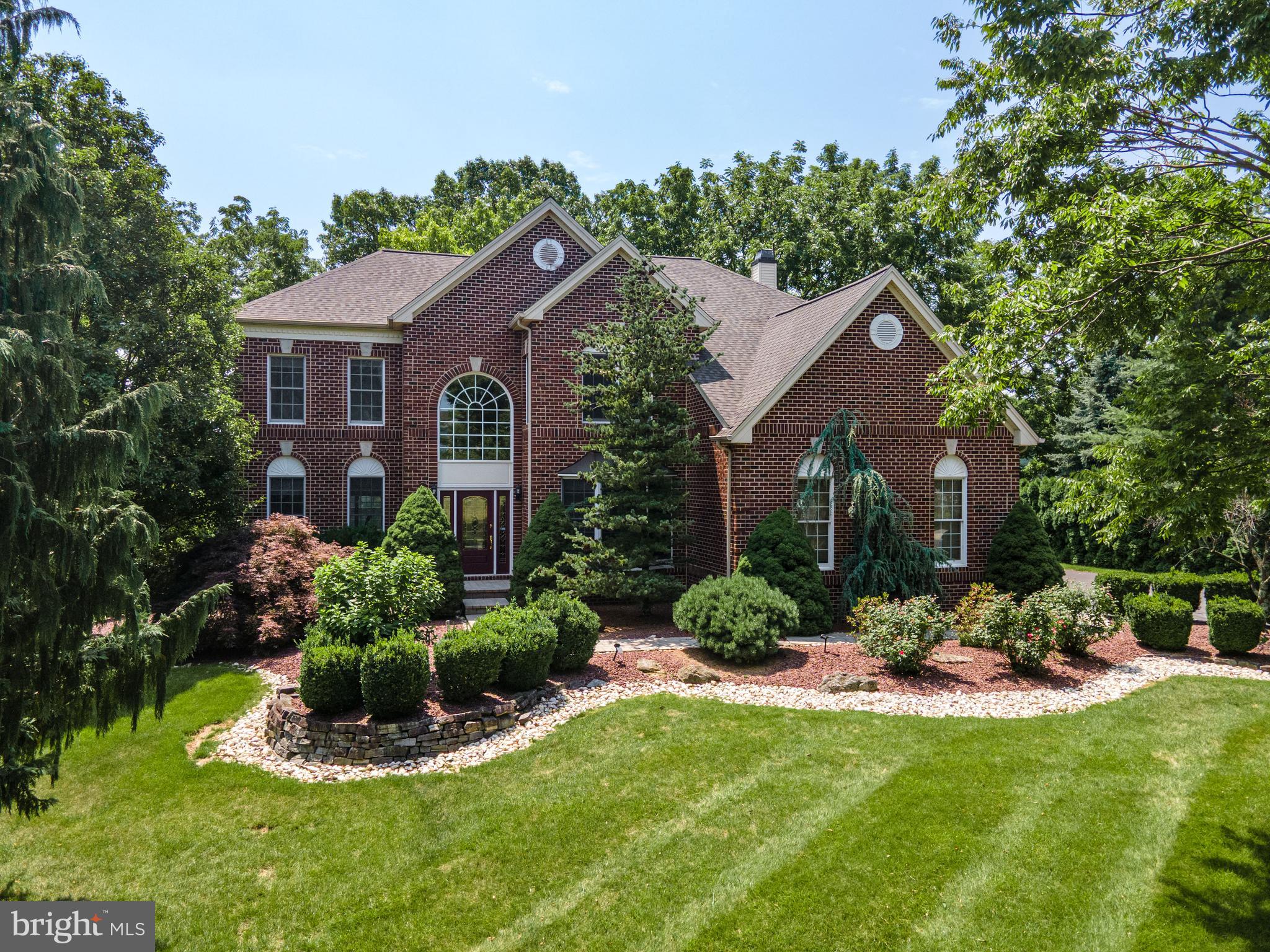 Welcome to this stunning full brick front Colonial in the prestigious Bethlehem Estates neighborhood with a Brand New Roof in 2025!! *Current sellers have fully upgraded the home over last Several Years including but not limited to refinishing all hardwood floors, replaced whole upstairs carpet, added a huge upscale patio, professionally landscaped front and backyard, fully finished basement, added addl. bath on 2nd floor, added a lot of molding throughout the house, added black wrought iron railing. Whole house painted when they moved in. Grand two-story foyer with hardwood floors, curved staircase with black wrought iron railing, crown molding, and wainscoting sets the tone for this elegant home. The open living and dining rooms are ideal for entertaining, while French doors lead to a private office. The impressive two-story family room features soaring ceilings, recessed lighting, and a floor-to-ceiling stacked stone wood-burning fireplace. The updated eat-in kitchen offers granite countertops, tiled backsplash, stainless steel appliances, double wall ovens, oversized center island with breakfast seating, and abundant cabinetry. A bright sunroom with vaulted ceiling, skylights, and sliding doors opens to the backyard. A laundry room and powder room complete the main level. The luxurious owner's suite features double-door entry, a sitting area, oversized walk-in closet with custom organizers, and a spa-like bath with dual granite vanities, tiled walk-in shower, Jacuzzi tub, vaulted ceiling, and private commode. A princess suite, two additional spacious bedrooms, and a full hall bath complete the second floor. The fully finished basement provides exceptional additional living space with a large recreation room, kitchenette featuring granite countertops and center island with bar seating, plus a full bath—perfect for entertaining, guests, or extended living. Enjoy your private backyard retreat featuring black wrought iron fencing, a huge paver patio with gazebo for your big parties, stone retaining wall, and playset. A three-car side-entry garage and expansive paved driveway complete this exceptional home. Conveniently located close to major highways US-22, PA-33 and I-78 for easy commute, Green Pond Golf Course, Moravian Academy, St Lukes Hospital, shops and more! Offering over-the-top craftsmanship, spacious living areas, and an unbeatable location in one of the Lehigh Valley's most sought-after neighborhoods, this is luxury living at its finest!