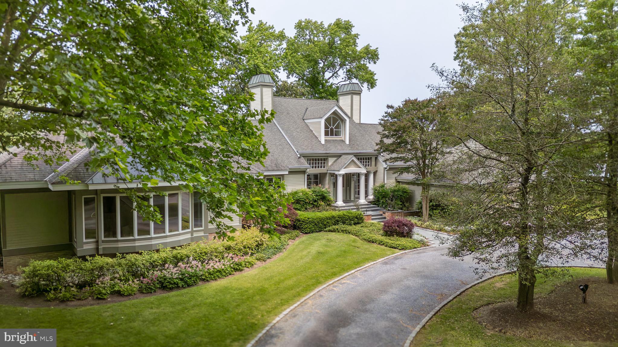 Your own private resort awaits you! This stunning 4-bedroom contemporary estate offers a beautifully landscaped parklike setting on a 7.26 acre point of land with 1,089 feet of frontage and private dock on Plaindealing Creek. This sophisticated home was designed by Alan Meyers, a celebrated Washington DC architect. The one level main house has 3 bedrooms, 2.5 baths and a 2-car garage. Your guests won’t want to leave the private 1-bedroom guest house with a full kitchen, 2 car garage and spacious living area that overlooks the water. The main residence offers highly crafted custom features including custom moldings, wood paneling, extensive built-ins and wide plank quartersawn white oak flooring. You will enjoy breathtaking panoramic water views from all rooms. The great room features a soaring cathedral ceiling, fireplace with custom limestone surround and hearth and a wall of glass overlooking the beautiful waterside pool and waterfront beyond. An outdoor entertaining deck features areas for lounging and dining and a 6-person hot tub. The kitchen adjoins the great room and features maple cabinetry, Corian counters and a bar counter. The kitchen opens to a glass-walled sun/breakfast room with a wood paneled vaulted ceiling. The family/media room features detailed maple paneling, extensive built-ins and a separate office. Not to be overlooked is the beautiful powder room that is a creative gem! The primary bedroom suite is a private haven featuring a built-in king-size bed that overlooks the waterfront, a sitting room and a luxurious spa-like bathroom that also enjoys a water view. The guest wing features 2 guest bedrooms with water views and 2 full bathrooms. There is a full-size laundry room, a separate pantry and more than ample closet space throughout the home. No detail has been spared in this beautifully conceived property. The home is well located in between Historic Easton and St. Michaels and their wonderful amenities, shopping and great restaurants. ** Please click on the movie camera icon to enjoy the virtual tour and floor plans that are keyed to the photos.