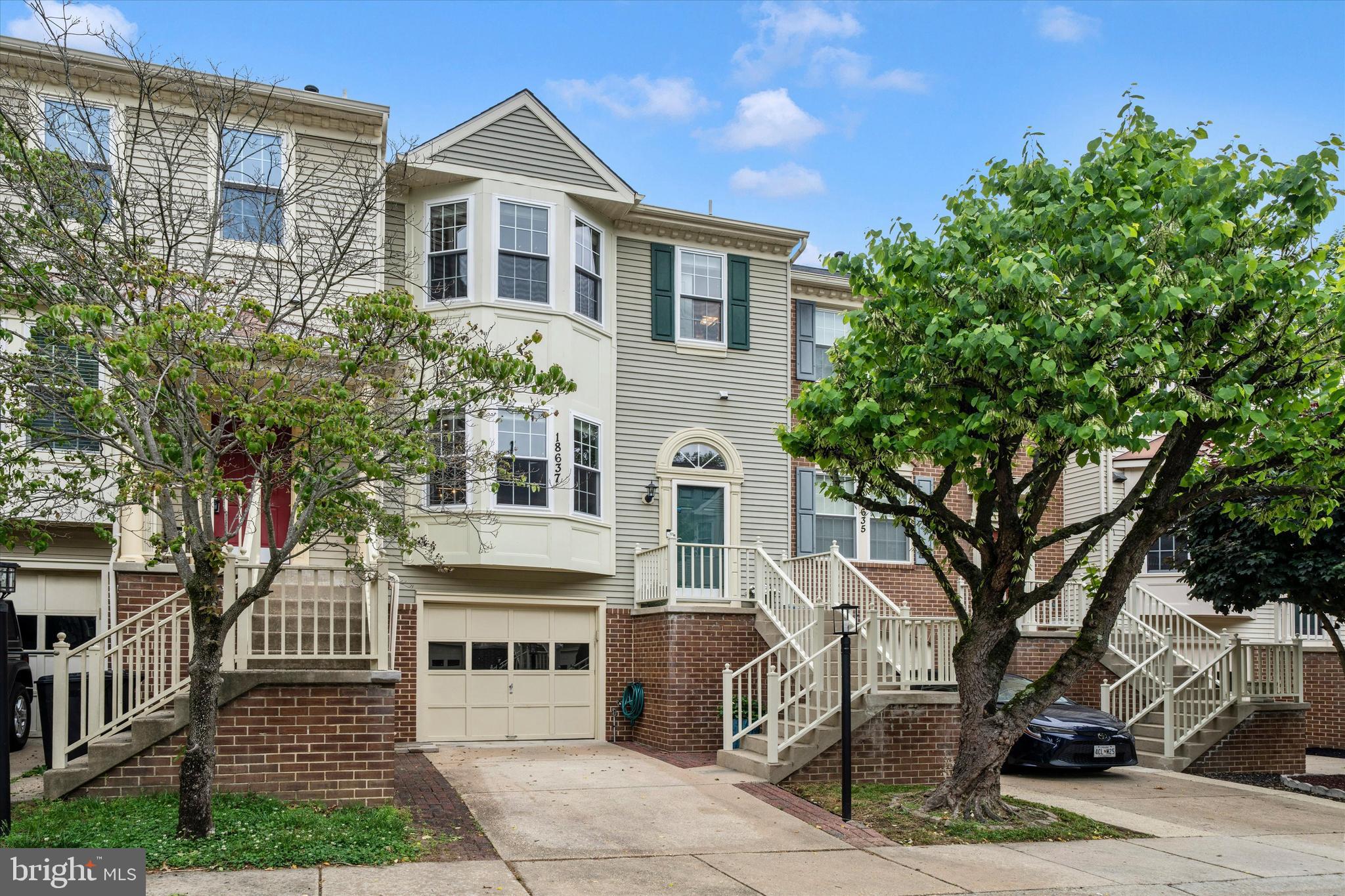 Welcome to this beautifully appointed and updated garage townhome in the highly sought-after James Creek community! This exceptional home features an open and airy floor plan with bump-out bay windows on both the main and upper levels, filling the home with abundant natural light. The main level showcases gleaming hardwood floors and an updated gourmet kitchen complete with granite countertops, stainless steel appliances, ample cabinetry, new under-cabinet lighting, and updated downlighting that enhances both the kitchen and lower level spaces.

The spacious primary suite offers a vaulted ceiling and a stunning newly renovated spa-inspired primary bathroom completed in 2025. Additional updates include brand-new windows throughout the home in 2025 and a new roof installed in 2024, providing peace of mind for years to come.

The finished lower level features a spacious recreation room with a cozy wood-burning fireplace and a rough-in for a future bathroom, offering excellent flexibility for additional living or entertaining space. The laundry and finished one car garage on this level complete this space.
Enjoy outdoor living with a large deck off the main level, perfect for gatherings and summer evenings, along with a fully fenced backyard featuring a patio area and lawn space for relaxing, gardening, or play.

Ideally situated within the community, this home offers an excellent location near the neighborhood swimming pool and is conveniently close to shopping, dining, parks, and major commuter routes. This special home combines comfort, style, and functionality in one of the area’s most desirable communities!