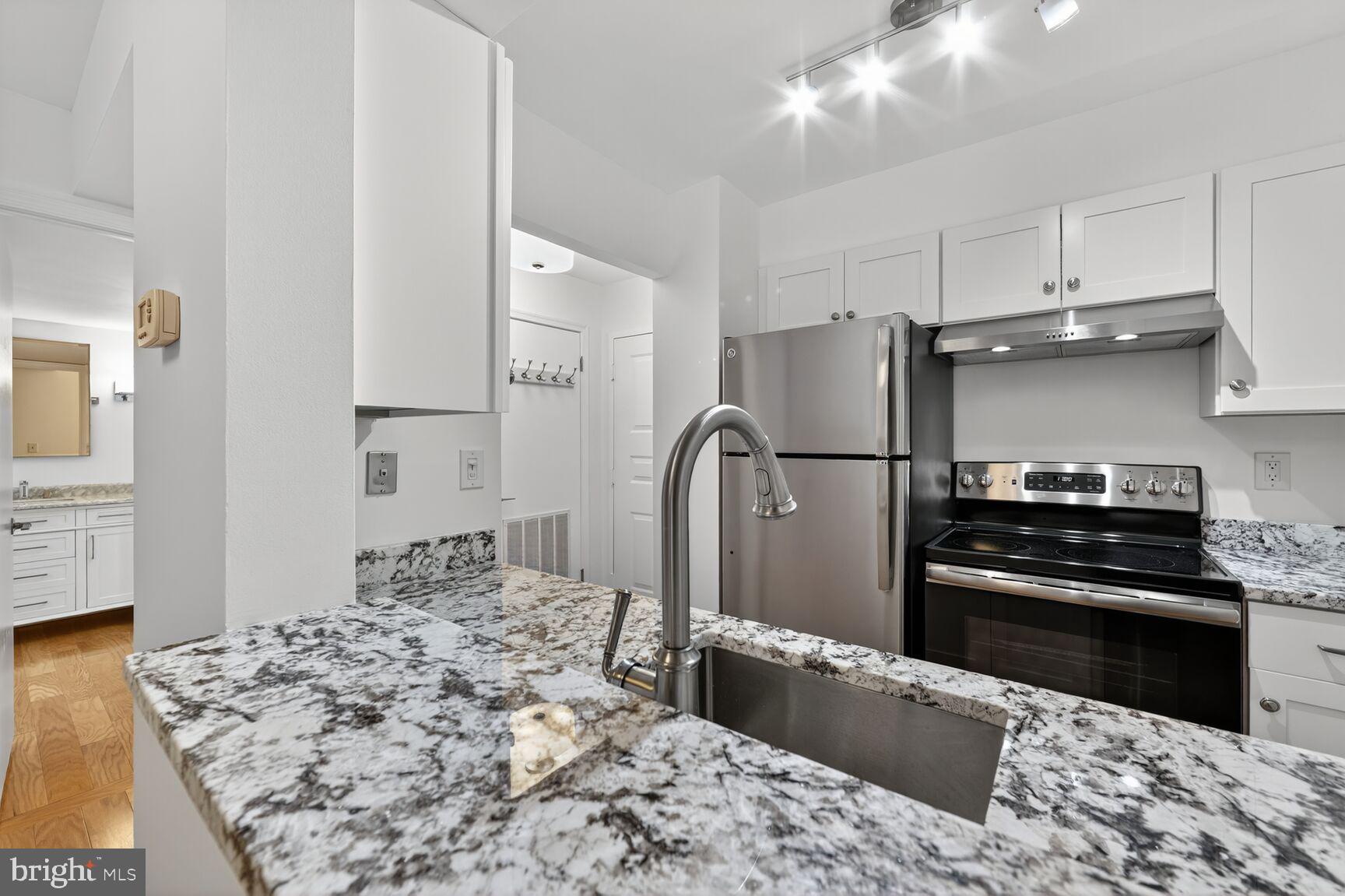 TENS OF THOUSANDS in UPGRADES to this PRISTINE cozy studio in an amazing location STEPS FROM DC on QUIET side of building. Building is conventional, VA, FHA approved!  This fully renovated studio unit is in like-new condition.  Gourmet kitchen with granite counters & stainless appliances.  Super high-end bath with designer tile work and custom vanity.  New hardwood floors.  Balcony overlooking quiet side of building (not toward I-66).  Washer / dryer IN UNIT.  Outstanding amenities include outdoor pool, (rare) tennis court, fitness center, library and community room.  Note: Common areas being renovated this year with modern finishes.  Walk to Courthouse Metro AND Georgetown.  Bike trail runs in front of building.  The ultimate pied-a-terre in a prime location.