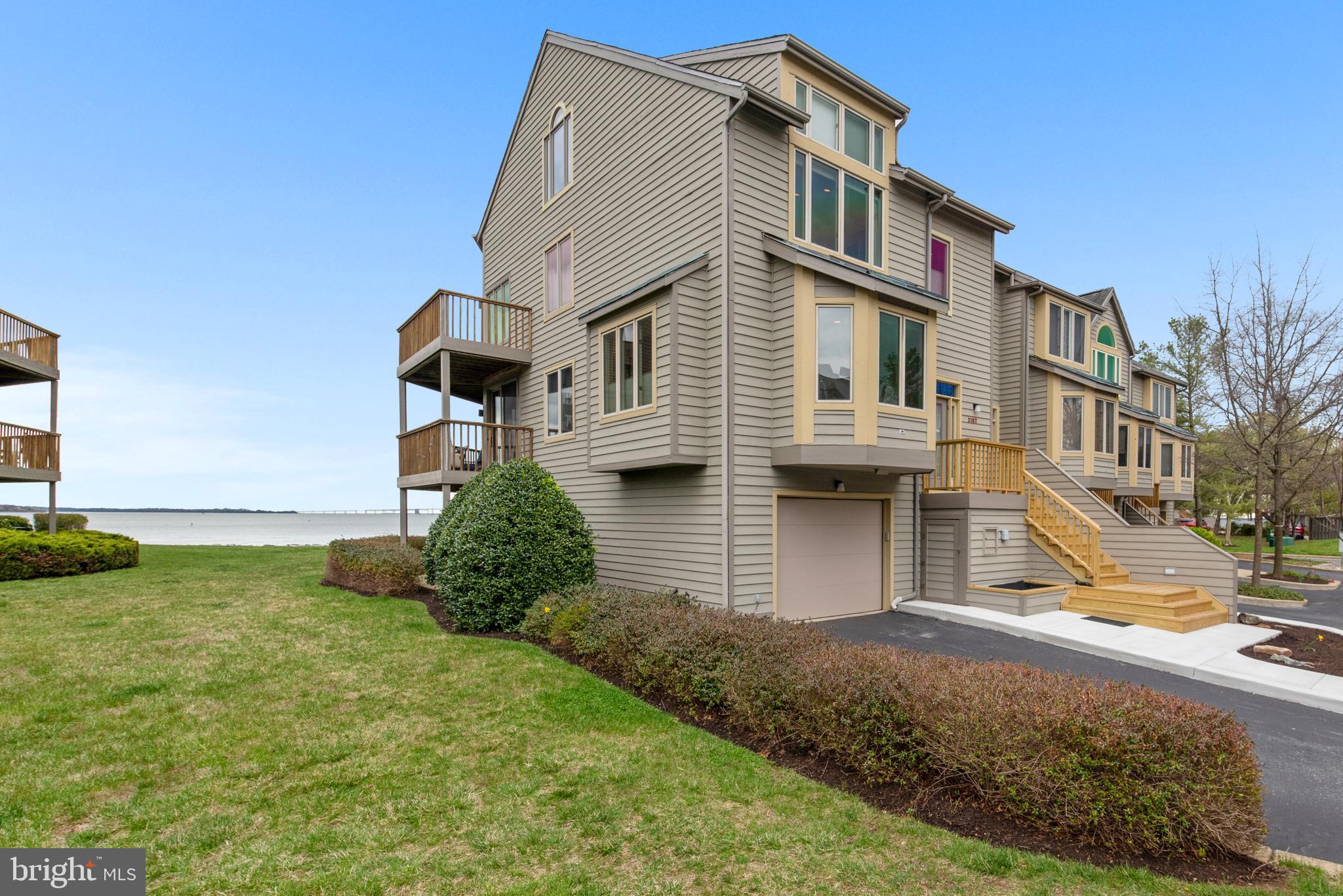 Breathtaking Vistas from the edge of the Chesapeake Bay!  Luxurious end unit 4-level townhome with elevator.  Spectacular upgrades include gourmet kitchen and 4.5 updated bathrooms.  Hardwood floors throughout, 2 cozy fireplaces, lower level with custom wet bar and walk out to community beach.  Primary suite showcases custom cabinetry by skilled craftsmen, walk-in shower and double vanities.  Fourth level with full bath, 2 large walk-in closets.   Gated Community with numerous amenities including pool, tennis, marina, beaches and much more.  Association responsible for roof, siding, decks and stairs.
