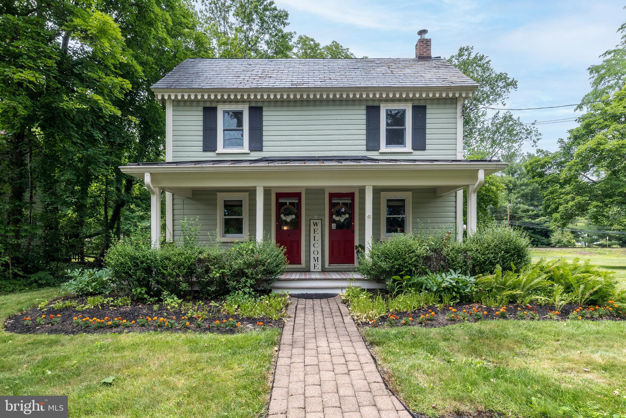 **Open House Wednesday July 1st 5pm - 7pm** Welcome to this charming turn-of-the-century home nestled on a beautiful peaceful lot in the heart of New Britain Borough. Rich in character and warmth, this 3-bedroom, 2-bath home offers the perfect blend of timeless craftsmanship and everyday comfort. The spacious front porch welcomes you to relax and enjoy the quiet surroundings, while wide plank pine floors add warmth and historic charm throughout much of the main level. The generously sized living room provides plenty of space for gathering with family and friends, and offers a cozy nook that's perfect for office or library space and is connected to the dining area. Designed for the convenience of first-floor living, the current owners have thoughtfully repurposed the family room into a spacious primary bedroom featuring a cozy propane fireplace and barn doors for privacy. The kitchen offers ample cabinetry, ceramic tile countertops, and picturesque views of the beautiful backyard. A full bath with convenient laundry area completes the main level. Upstairs, you'll find three bedrooms, a full hall bath with direct access from the hall and one bedroom, and a finished walk-up attic offering versatile space for storage, or a playroom. Step outside to an expansive paver patio overlooking the picturesque backyard, creating the ideal setting for entertaining, outdoor dining, or simply relaxing beneath the shade of mature trees. A truly exceptional feature of this property is the detached garage with a fully equipped one-bedroom accessory dwelling/apartment featuring an additional 1000+ square feet of living space including a full eat-in kitchen, private office, living room, one-and-a-half baths, and loft bedroom. One of the garage bays is heated and air conditioned, making it an ideal workshop, studio, or hobby space and also houses the laundry hook-up for the apartment. Whether you're seeking multigenerational living, guest accommodations, or additional flexibility, this unique property offers endless possibilities. Buyer is responsible for confirming the permitted use of the accessory dwelling with New Britain Borough. Conveniently located within walking distance of the New Britain SEPTA Regional Rail Station and just minutes from downtown Doylestown's shops, restaurants, parks, and cultural attractions, this one-of-a-kind property combines timeless charm with exceptional versatility and is ready to welcome its next owners.