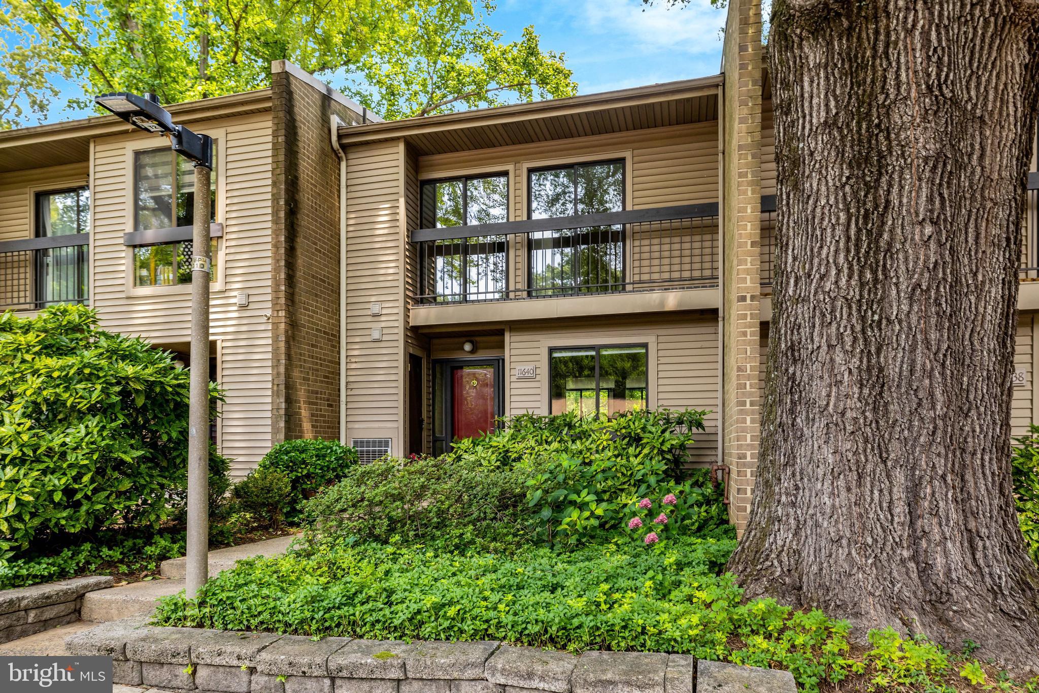 THE PERFECT CONDO/TOWNHOME - OPEN SATURDAY, 7/18 AND SUNDAY, 7/19 FROM 2-4PM EACH DAY. This condo/townhome, located just minutes from Reston Town Center and the Wiehle-Reston East Metro Station, offers approximately 1,636 square feet across 3 levels. The home backs onto Reston National Golf Course, with picturesque views, manicured grounds, and walking trails just around the corner. The main level features newer LVP flooring, a custom-designed kitchen, an updated powder room, and a spacious living and dining area with a wood-burning fireplace and sliding doors to a large private deck overlooking the golf course. Upstairs, newer carpet runs throughout a spacious primary suite with lovely views, a refreshed bathroom, and dual closets — one with a built-in organizer — plus 2 additional bedrooms and a refreshed hall bath, for a total of 3 bedrooms and 2 baths on the upper level. The lower level offers a washer, dryer, utility area, and ample storage. The home includes a coveted covered parking space, plus abundant unassigned parking in the community. Beautifully maintained and thoughtfully updated, this home is ready for its new owner.