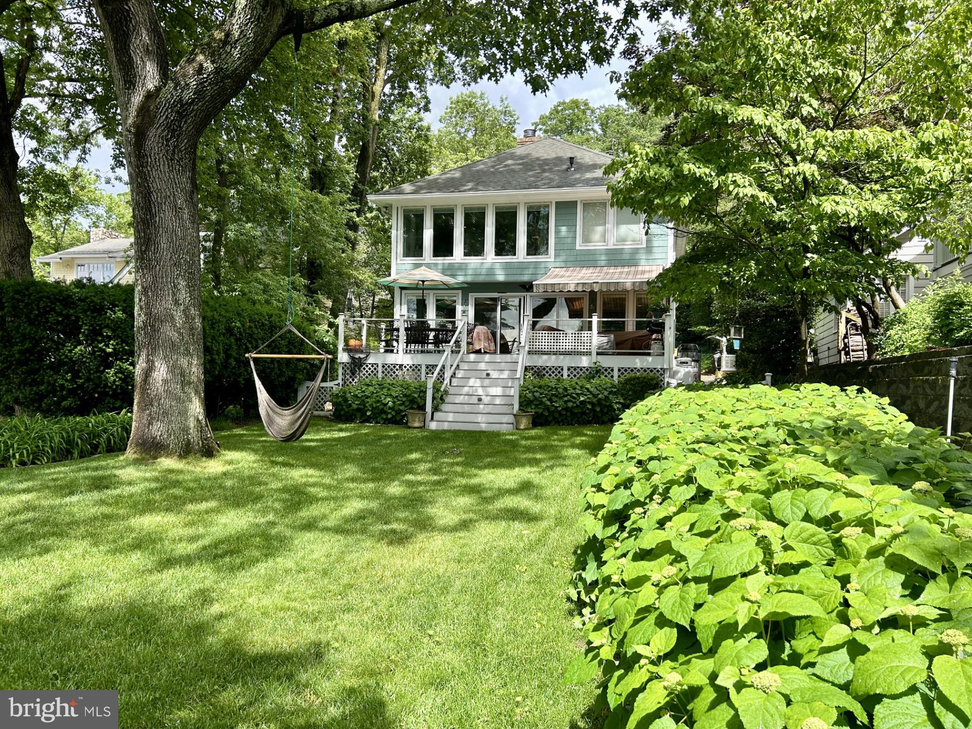 Open House cancelled.  Home is under contract. Fantastic waterfront with breathtaking views from most rooms! A beautiful landscaped and level backyard leads to a sandy beach and easy access to the new dock with multiple boat lifts and slip! The 2 boat lifts include 15,000 lb. and 2,500 lb. lifts, 2 jet ski lifts and a deep slip for a sailboat. Water depth is 5' MLW.  Enjoy being on vacation all year long on the Severn River! Head to Annapolis or the Chesapeake Bay for the day!  Enjoy crabs under the deck awning and a beautiful sunset on the waterfront patio! This wonderful home has 3 bedrooms, 3 1/2 baths, family room with a wood stove, bar area with ice maker, office, loft and finished basement.  The generous primary suite overlooks the water and includes a walk-in closet, fireplace and a lovely bath with dual sinks, shower and separate soaking tub.  The basement has a rec room, a room used as a 4th bedroom, full bath, workshop area, storage room and walkout to storage under the deck.  Also included are a Generac whole house and dock generator, irrigation, outside shower and a hot tub! The summer is ready for you!