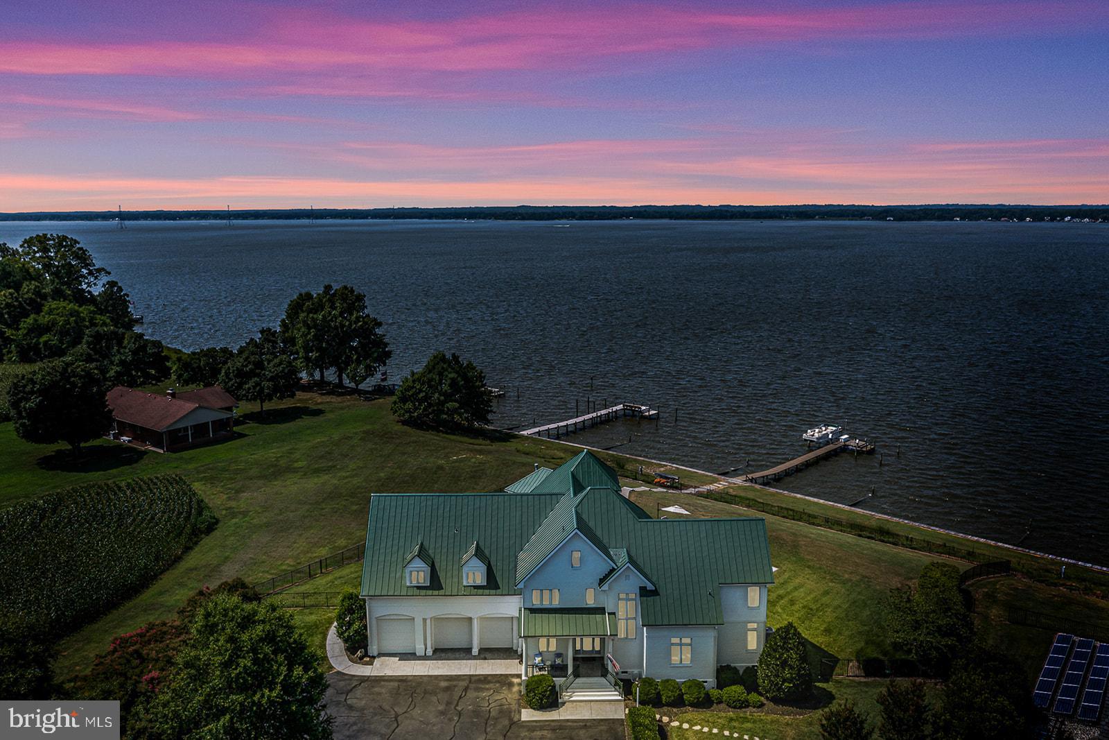 Welcome to 76 Level Green Landing! A truly distinctive waterfront property on the Rappahannock River! This Luxurious Estate has been designed with no detail left undone & features 3 levels of gorgeous style, 3 Car Garage, 7 bedrooms, 8.5 Baths (6 bedrooms are en-suites). The lavish interior features a beautiful entry Foyer, Gourmet Kitchen with all the bells & whistles, Island bar to seat 12+, Media Room/Den, Utility Room, Powder Room, Large open Dining Area, unique Great Room with Superior Views & soaring ceilings, Stunning Stone gas log Fireplace, Surround sound Wired throughout, main level owners Suite with whirlpool plus steam shower, Walk-in closets in 6 bedrooms, plus ample storage in the 34x 16 walk-in attic. Carefully Tailored to have water Views in almost every room & Still keep a striking Curb appeal both waterside and Roadside, this home is a "Show-Stopper" that must be seen in person to appreciate. The Entertaining areas flow seamlessly to the exterior w/ highlights such as : Salt water Pool, Wrap-around Screen Porch, extensive Patio area, Pool House w/kitchenette plus full Bath, outdoor Shower, Fenced yard & more. Other highlights include: Paved & Tree lined Driveway ,Brick exterior, Metal Roof, unique light fixtures & ceiling fans throughout, whole home automation system, plus so much more! The Very well Manicured & irrigated 2.64 acres makes it feel like a tranquil resort. The Shoreline is protected by a seawall & the long pier has a lounge area along with a boat lift. One Look will make any Buyer want to call this their Northern Neck of Va Home!!