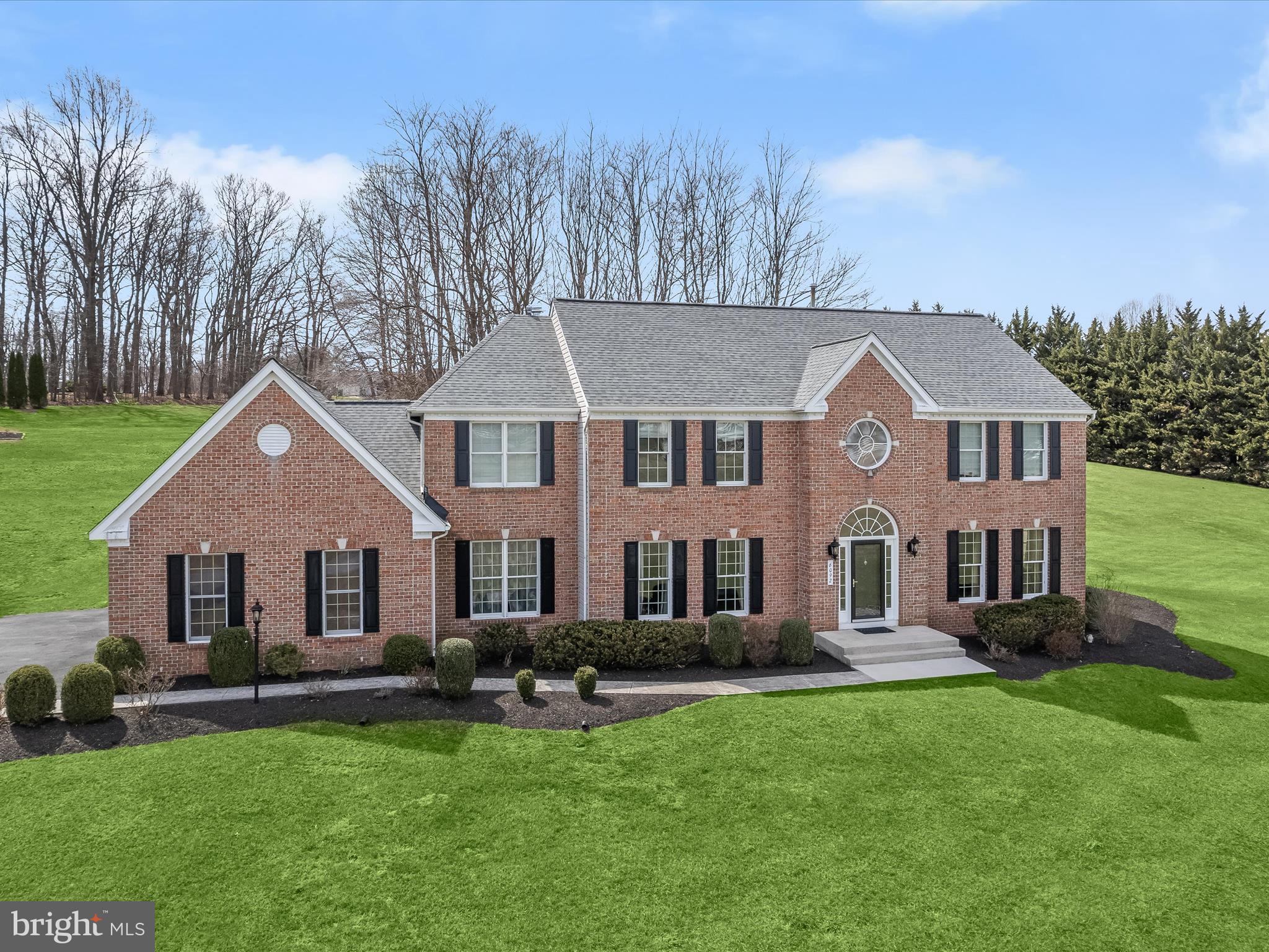 Exquisite Brick Front Colonial in the Prestigious Challedon Community
Nestled on three lushly landscaped acres, this stunning brick-front colonial offers over 5,000 sq. ft. of luxurious living space, thoughtfully updated to blend timeless elegance with modern convenience. Recent enhancements include a new roof (2019), siding, HVAC, renovated basement, gourmet kitchen, paved driveway, and more!  Step into the grand two-story foyer, where architectural columns frame the formal living and dining rooms, setting the tone for this sophisticated estate. The heart of the home is the gourmet kitchen, a chef’s dream featuring an oversized island with gas cooktop and breakfast bar, gleaming granite countertops, stainless steel appliances, and an adjoining sunlit breakfast room with direct access to the expansive deck.   Unwind in the inviting family room, graced with a cozy gas fireplace and elegant architectural columns. The main level also boasts a private home office, a well-appointed laundry and mudroom, and a stylish powder room for added convenience.  Retreat to the lavish primary suite, a sanctuary of relaxation with a see-through gas fireplace, a serene sitting area, a dramatic tray ceiling, and a spacious walk-in closet. The spa-like luxury en suite pampers with a soaking tub, separate shower, and dual vanities. A second bedroom features its own private bath, while two additional bedrooms share a beautifully designed dual-entry full bathroom.  The walkout lower level is an entertainer’s dream, featuring a huge recreation room, a home theater, a versatile bonus room, a full bathroom, and ample storage space.  Outdoor living is simply breathtaking—a huge Trex deck leads to an expansive stone patio with a built-in fire pit, all backing to mature trees for ultimate privacy.  Don’t miss this rare opportunity to own a true masterpiece in Challedon—where luxury, privacy, and timeless elegance converge.