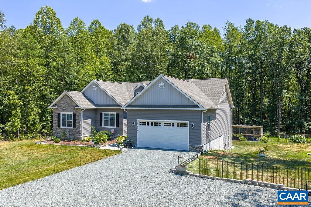 Welcome to this spacious, light-filled home where large rooms and an open floor plan create a warm and inviting atmosphere. At the heart of the home is a generous kitchen featuring granite countertops and abundant workspace, perfect for cooking, entertaining, and everyday living. A beautiful diningroom connects seamlessly to both an open-air deck and a covered screened porch, offering wonderful spaces to relax and enjoy the outdoors in every season.  The thoughtfully designed split-bedroom floor plan provides privacy, while the central living room is anchored by a cozy gas log fireplace that adds warmth and charm. The primary suite features a large walk-in closet, a luxurious soaking tub, and a separate shower. On clear, starry evenings, step directly from the primary bedroom onto your private screened porch, a peaceful retreat for unwinding at the end of the day. The lower level offers even more living space with two additional bedrooms, a full bath, and a large family room?ideal for guests, hobbies, or a home theater. Storage is abundant throughout the home, including an exceptionally large pantry you won?t want to miss. Outside, the property continues to impress with an extra-large parking area,  shed, greenhouse, and more.,Fireplace in Living Room