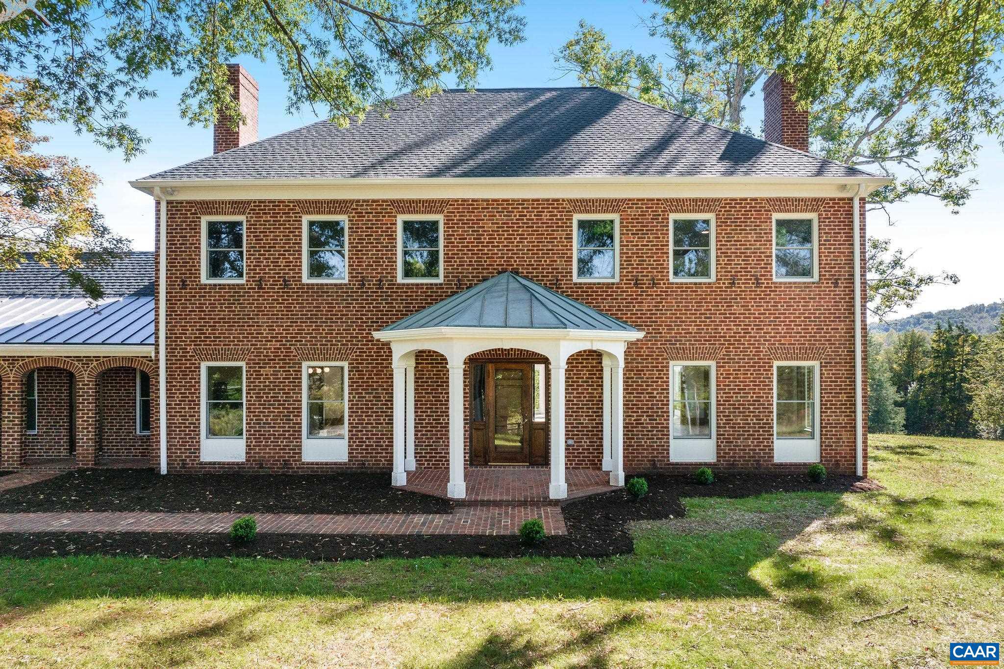 Exquisite home on 5 acres!  Nestled between Charlottesville and Ivy in the Western Albemarle School District, this 5,735 sq. ft. home has undergone a massive renovation to restore its classic beauty while incorporating modern amenities. With 10-ft ceilings, oak floors, and three fireplaces, it offers four bedrooms, four and a half baths, including a garage apartment. The remodeled gourmet kitchen features double dishwashers, ovens, refrigerators, a wine fridge, and a butler's pantry. A stunning two-story sunroom fills the home with natural light and mountain views, blending indoor and outdoor living seamlessly. Exceptional craftsmanship and detail are found throughout.