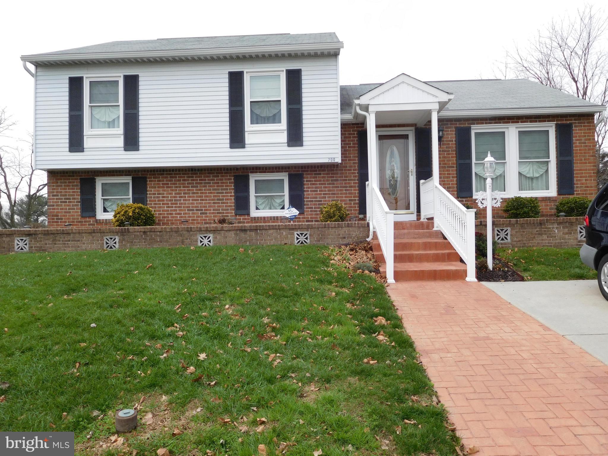 Showhouse Perfection! An  inviting 4-level split home is ready for your family, Remodeled kitchen, stainless appliances  2012, sparkling hardwood, 6 panel doors, 3 ceiling fans, Roof 2003, Gutters & downspouts 2014. Lowest level finished, great storage areas.   Deck & vinyl fencing, off street parking pad.  Corner lot & great yard. Loaded with extras! " L shape " family room.
