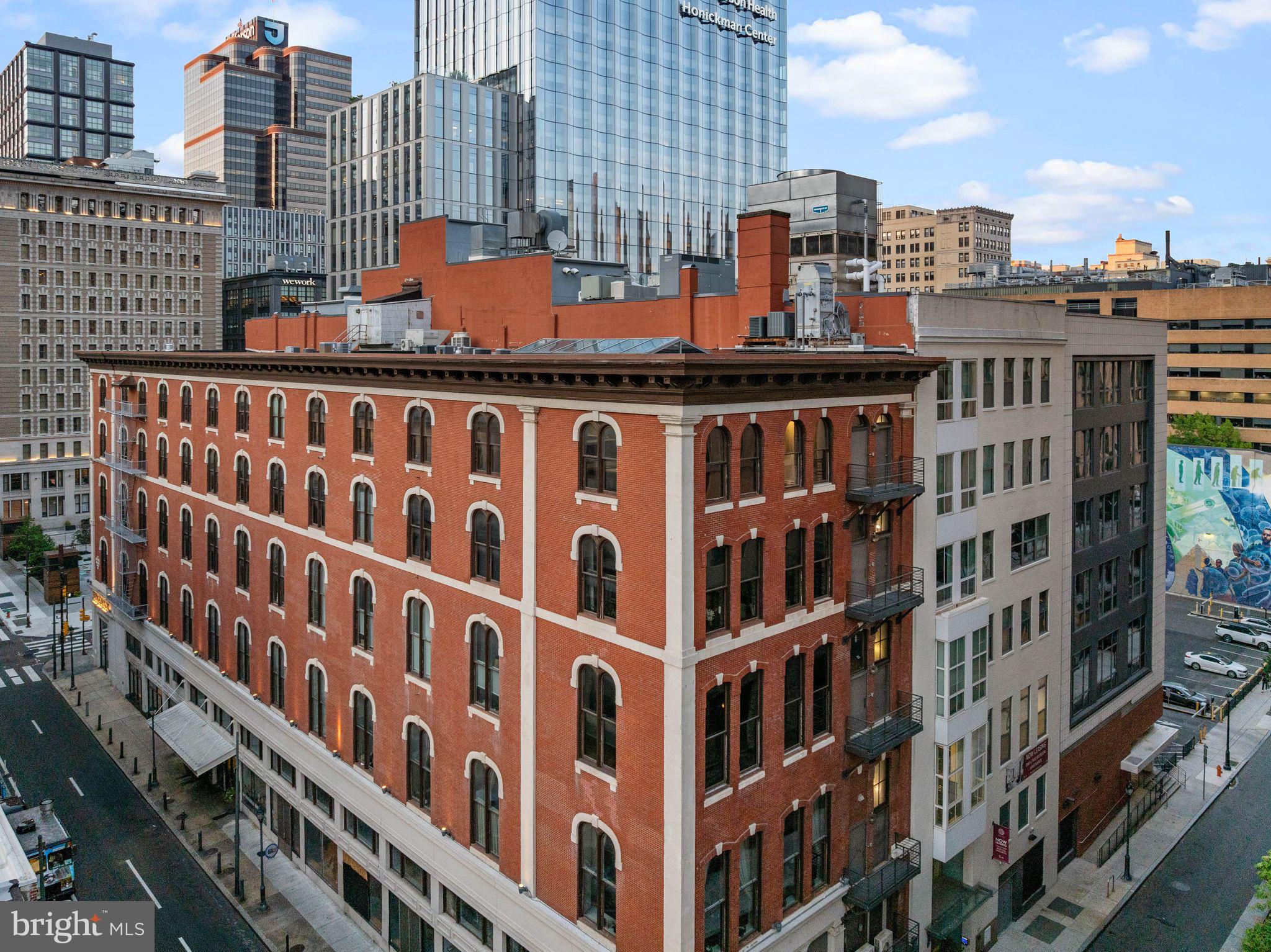 Taxes reduced! The Pinnacle of Loft Living in Philadelphia. Welcome to the Penthouse at the White Building. A roughly 3150 square foot super deluxe 2 bed 3 full bath condo with ROOF RIGHTS! Spectacular at every turn! Soaring 13 Plus foot ceilings, a roughly 30 by 15 foot mega skylight, 14 oversized windows combine to create one of the most sensational spaces in Philadelphia. The exposed brick in conjunction with the sweeping white walls make this condo an art collectors dream. If you are an entertainer this is heaven. The expansive kitchen separates the living and dining areas from the bedrooms. A 9.5 foot marble island is your center piece. Abundant storage and pantry cabinetry. Top of the line fixtures and appliances including a commercial vented Wolf range hood. You’ll enjoy cooking here under the Skys above.. literally! Off of the kitchen you’ll find an office area for the “work from home” lifestyle. Passed the kitchen and through a handsome custom swing door you’ll enter a primary suite that you will never forget! Grand and luxurious, this is a dramatic bedroom oasis. 2 Custom glass barn doors. A stone TV wall. A walk-in closet the size of a bedroom with a beautiful custom fit out. A 5 piece spa bathroom with a gorgeous marble vanity, automated toilet, stunning lighting detail, a soaking tub and a steam shower. Off of the kitchen you'll find a very nice guest bedroom with sunset and skyline exposure, a high-end electronic murphy bed and a cool 4 piece bathroom. Sun rise to sun down you’ll be amazed by how the light shines through out the entire condo. Southern and western light! Features include: Control 4 system for HVAC, Lighting, Sound. Electronic rollers shades throughout. Electronic Milano Murphy bed / couch combo. Its hi-tech! This space could be turned back into a 3 bedroom if preferred which offers the next owner optionality. Live in the heart of Midtown and above the amazing restaurant lineup this area has to offer. Including El Vez, Sampan, Alpin Rose, Prunello, Barbuzzo and Pearl & Mary. The White Building is surrounded by tons of exciting brand new developments that will elevate this neighborhood encompassing Market East to new heights. Over ONE BILLION of investment within 2 blocks. This boutique condo building was originally constructed in 1867 as factory space for the SS White Dental Manufacturing Company. It houses a gym and you'll enjoy low condo fees. Parking can be rented at any of the many surrounding garages.