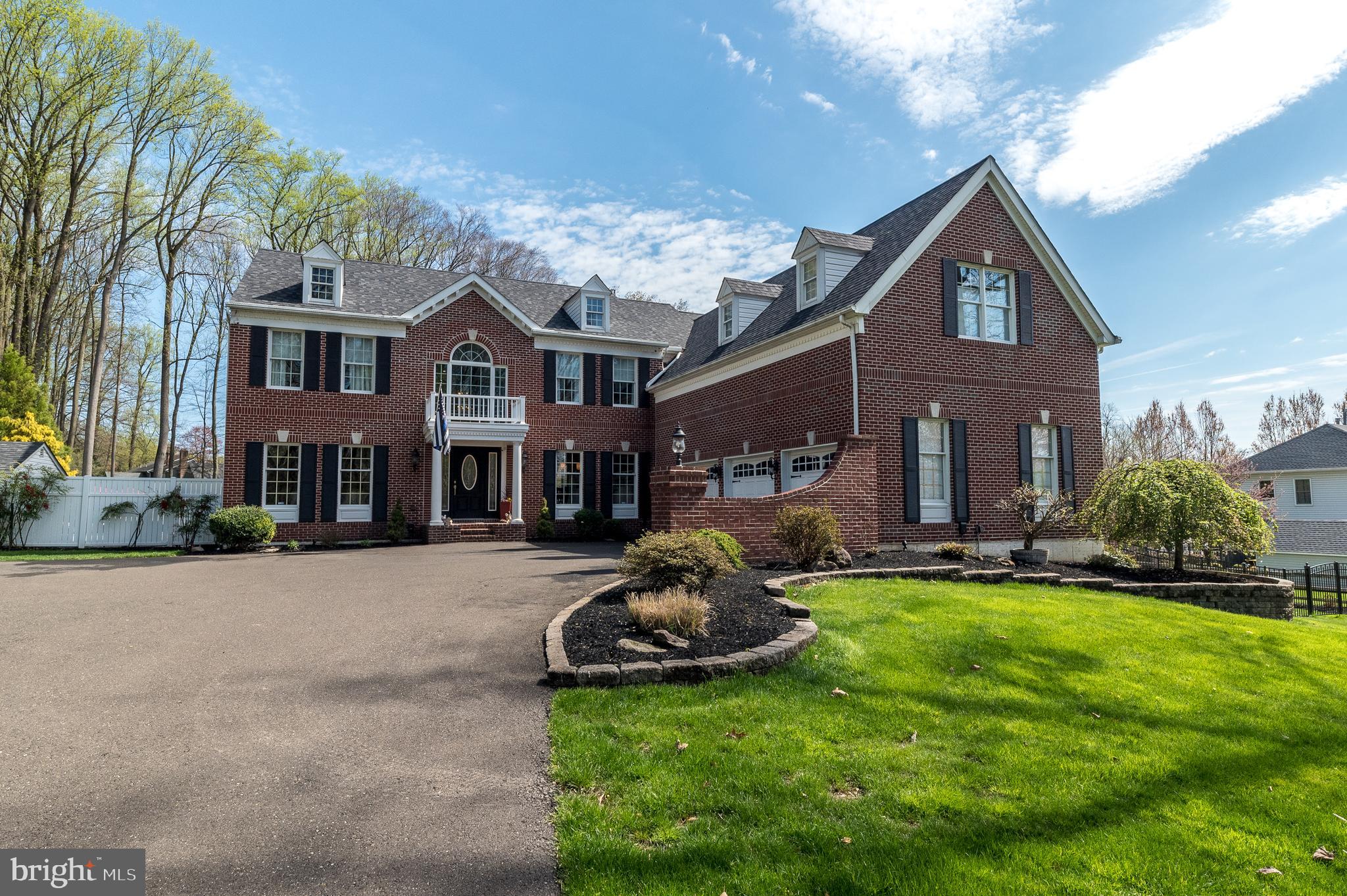 This magnificent brick home is nestled on a parklike 1.56 acres in the prestigious community of Buckingham Woods, with walking paths to nearby Hansell and Bush parks. The grand 2-story entrance foyer features an impressive butterfly staircase with chandelier on a hoist. Throughout the first floor, rich wood floors and 9-foot ceilings create a sense of spaciousness and warmth. The living room and dining room are adorned with crown and picture frame molding, providing a picturesque backdrop for hosting gatherings of any size. The kitchen is a chef's dream, tastefully remodeled with leathered granite counters and a large island with seating. Top-of-the-line appliances include a 60" Wolf dual range (electric ovens/gas burners) with pot filler, exhaust hood, Sub-Zero 42" refrigerator, Bosch dishwasher, and GE space saver microwave. Adjacent to the kitchen, a sunny breakfast room opens onto the expansive outdoor living areas, complete with a large deck, paver patio, and inviting inground pool—perfect for al fresco dining and entertaining. The two-story family room beckons with its dramatic floor-to-ceiling fireplace flanked by sliding glass doors, filling the space with natural light. A private study beckons with plush Berber carpeting and a wall of built-ins, offering a serene retreat for work or relaxation. A convenient half-bath completes this level. Upstairs, two staircases lead to the sleeping quarters, where a sumptuous primary bedroom suite awaits. Double doors open to reveal a cathedral ceiling, private den, sitting area, dressing area with walk-in closets, and an ensuite bathroom with a soaking tub, tiled shower, and large vanity with double sinks. A Prince/Princess suite is complete with its own ensuite bathroom, while two additional bedrooms share a Jack 'n Jill style bathroom. The finished basement offers even more living and entertaining space. Situated in the award-winning Central Bucks School District with many private schools in the area. Just minutes from downtown Doylestown for dining, shopping, or cultural events. This home offers the perfect blend of country and convenience in the heart of Bucks County  - embrace the lifestyle this extraordinary residence has to offer!