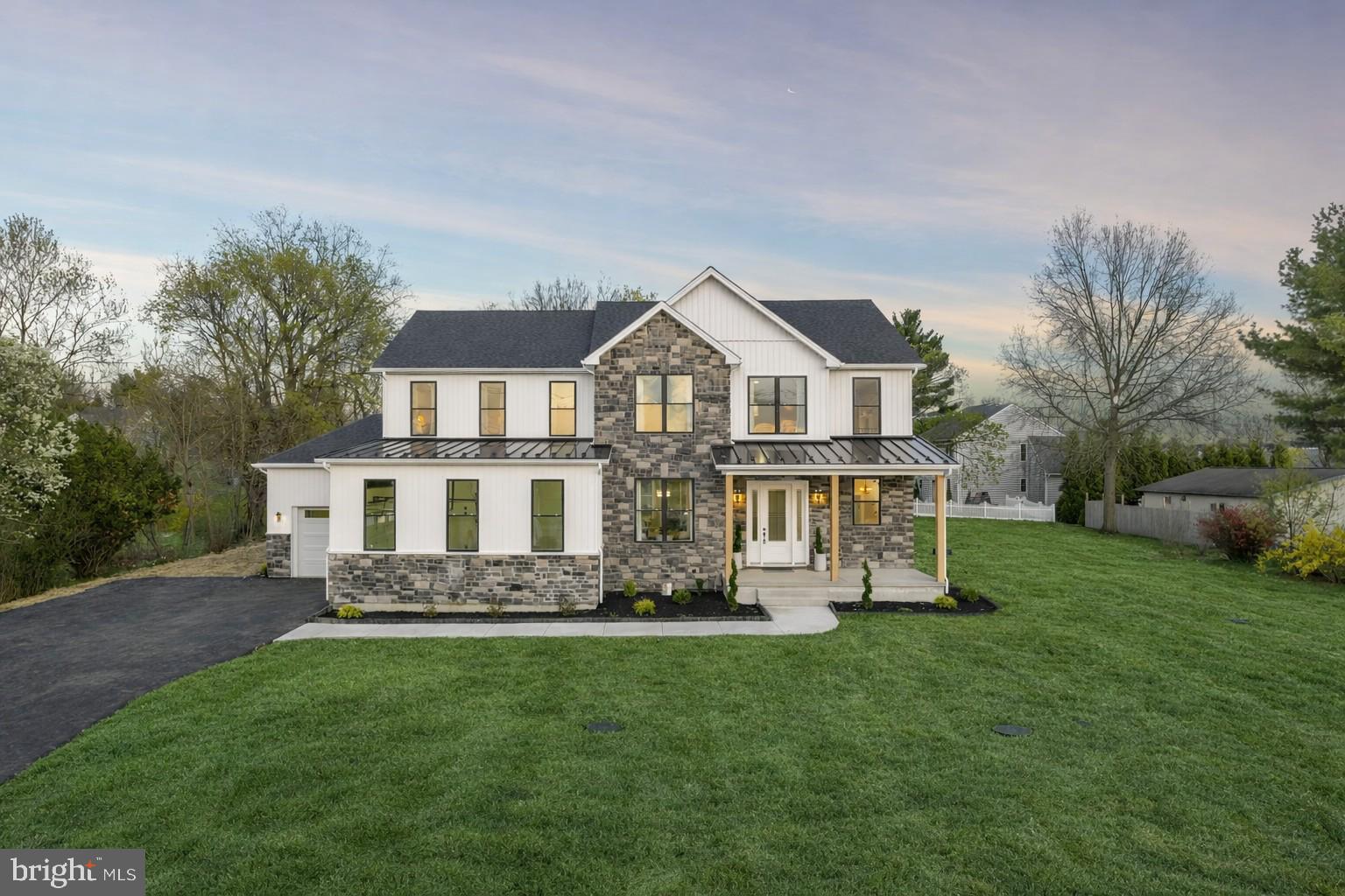 Set just minutes from Phoenixville Boro, this newly built home offers over 6,000 square feet of finished living space designed for how you actually live. It’s the rare combination of space, style, and location that’s hard to find, especially this close to everything Phoenixville has to offer.

From the moment you step inside, the scale and natural light stand out. Ten-foot ceilings, clean modern finishes, and a thoughtful layout create a home that feels both elevated and comfortable. The main living areas flow seamlessly, making everyday living easy and entertaining even better.

The kitchen is truly the heart of the home, anchored by an oversized island and surrounded by stylish cabinetry, a commercial-grade six-burner range with double oven, and a custom Calcutta quartz surface. The scullery adds a level of convenience that sets this home apart, complete with additional storage, a sink, and a second dishwasher.

Just beyond, the kitchen opens into a stunning morning room with a cathedral ceiling and wood beams, and into the family room with a floor-to-ceiling fireplace and direct access to the covered deck. This indoor-outdoor flow is where the home really shines.

The main level also includes a full bedroom and bath, ideal for guests or flexible living, along with a private office and a well-designed mudroom.

Outside, the covered composite deck with a gas fireplace creates a true extension of the home. The level yard offers plenty of space for a future pool, play, or outdoor entertaining.

Upstairs, the primary suite feels like a retreat, with two oversized walk-in closets and a spa-like bathroom featuring a freestanding soaking tub, oversized tile, and a walk-in shower with a vertical spa feature. Additional bedrooms are generously sized, including a Jack and Jill layout and a private en-suite, plus a bright loft and second-floor laundry.

The finished lower level adds even more flexibility, with a bar with leathered black counters, space for a gym, an oversized full bath, and accent walls with a fireplace.

With over 6,000 square feet of finished space, this home offers the kind of layout, design, and functionality that’s hard to replicate. And just minutes from Phoenixville’s restaurants, shops, and trails, with easy access to Route 422, SEI, and GSK, you get both space and convenience in one location.