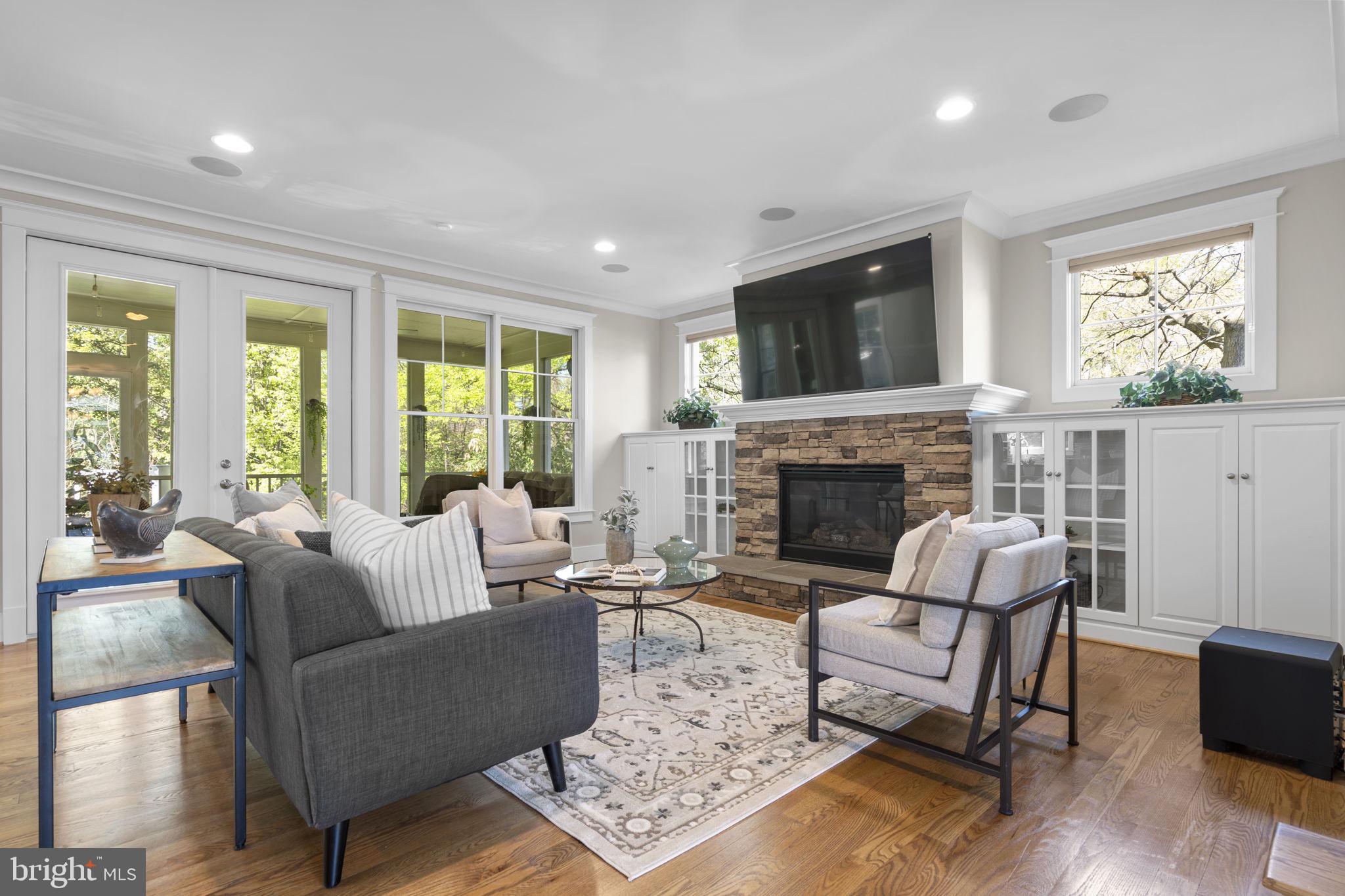 Nestled on a beautifully landscaped .84-acre lot, this custom-built Falls Church residence epitomizes exceptional space, privacy, and everyday luxury. The backyard is more than a retreat—it’s an outdoor oasis, complete with a screened-in porch for tranquil evenings, a firepit patio perfect for entertaining, a greenhouse for year-round gardening, a campfire, and a whimsical treehouse zone that encourages play, relaxation, and family connection throughout all seasons. The expertly designed landscaping in both the front and rear creates an elegant, welcoming environment that feels uniquely yours.
Built in 2014 by Stanley Martin Custom Homes, 7602 Virginia Lane presents over 5,600 square feet of thoughtfully finished living space across four expansive levels, featuring 6 bedrooms and 5.5 baths. The inviting wrap-around front porch not only sets a graceful tone but also offers a wonderful vantage point to enjoy the vibrant activity along the W&OD trail—watch children play, families stroll, or joggers and cyclists pass by, all fostering a strong sense of community. Craftsman and flagstone details further elevate the porch’s charm, welcoming guests into a gracious foyer highlighted by rich hardwood flooring and abundant natural light. Host elegant dinners in the formal dining room or retreat to a private office with French doors for peaceful, productive work-from-home days.
The gourmet kitchen is a dream for any chef, boasting a spacious center island, sunlit breakfast nook overlooking the backyard, and seamless transition into the family room with a cozy gas fireplace flanked by custom built-ins. Whether you’re hosting friends or enjoying a quiet evening, this space is designed for both celebration and comfort. The screened porch extends your living area outdoors, while the generous mudroom—with convenient access from the garage and front porch—simplifies daily life.
Upstairs, the owner’s suite is a true sanctuary, featuring a spa-inspired bathroom with frameless glass shower, dual shower heads, soaking tub, dual vanities, and a dedicated makeup area. The huge custom walk-in closet provides exceptional storage. Three additional bedrooms round out this level: one with a private ensuite, and two sharing a Jack-and-Jill bath, plus the spacious laundry room for utmost convenience.
The finished attic level offers flexible space with an L-shaped layout and full bath—ideal for a playroom, media center, fitness studio, or a welcoming guest suite. The fully finished daylight lower level is designed for fun and relaxation, complete with a spacious rec room with a home theater, a full bath, and a sixth bedroom perfect for guests, a second office, gym, or creative pursuits.
Exceptional amenities set this home apart: a 16-zone speaker system for immersive audio, a dedicated home theater, and an expandable Control4 system to manage sound, theatre and smart home features.  Additional highlights include a secure room, and the oversized two-car garage, which offers convenient dual access from both the front and rear. Outdoors, enjoy many enhancements—a smart irrigation system and front up-lighting, a lighted rear patio and firepit area, plus ample storage for all your outdoor gear and toys.
Discover a property that truly stands out for its space, adaptability, and lifestyle—embracing comfort, connection, and the very best of Falls Church living. Schedule your private tour today and let this extraordinary home welcome you.