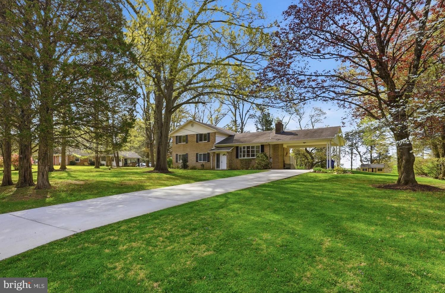 A classic mid-century modern (MCM) split-level home featuring a staggered layout with half-flights of stairs connecting four levels. With clean lines and functional design, this layout beautifully separates public and private spaces while maintaining a fluid, airy aesthetic. This customized brick home features six bedrooms and 3.5 bathrooms, ready to suit your needs—easy to keep as-is or redesign for your lifestyle! If you have a large family, frequently host out-of-town guests, or need dedicated office or craft spaces, this home easily accommodates everyone.

The kitchen is the heart of the home, offering space for a large table and plenty of counter space to match. Thanks to a convenient pass-through opening to the living room, no one gets left out of the conversation. Hardwood floors are waiting to be revealed beneath the carpeting in the living room and upstairs bedrooms (the primary bedroom photos show a preview of the gorgeous flooring!).

The home also features a cozy wood-burning fireplace in the living room, a den, a recreation room, and an abundance of storage space. Beautifully sited on a flat, maturely treed lot of nearly a full acre (.95 acres), the outdoor space is just as impressive. The backyard includes a large shed complete with electricity and a workbench, plus a greenhouse to get your seasonal seedlings started. There is endless room for gardens, play, hosting parties, pets, or a future addition.

Ideally located close to Olney and Silver Spring shopping areas, you will enjoy easy access to the ICC (I-200), connecting you directly to I-270 and I-95 for an easy commute. Plus, it's just 3 miles to the Glenmont Metro Red Line (an average 10-minute drive).