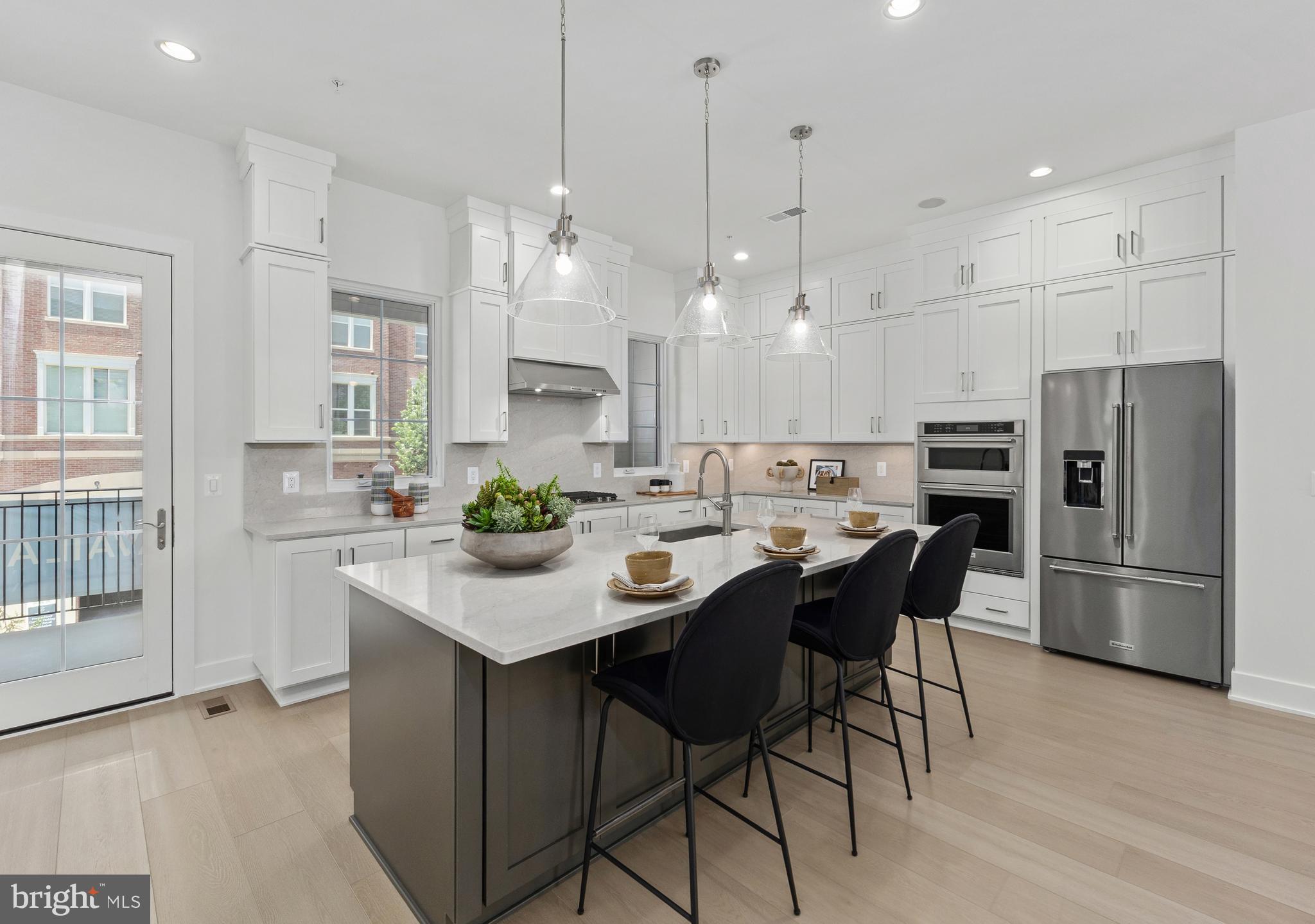 Discover refined living in this spacious four-level elevator home, thoughtfully designed to accommodate a variety of lifestyles with its versatile layout and elegant finishes. The entry level features a private bedroom with ensuite bath—perfect for guests or multi-generational living—alongside a large flex room ideal for a home office, gym, or media room. Upstairs, the open-concept main living area boasts a sophisticated great room, casual dining space, and a beautifully appointed kitchen with a large island, walk-in pantry, and direct access to a covered porch for seamless indoor-outdoor living. The luxurious primary suite includes a spacious walk-in closet and spa-inspired bath with a dual-sink vanity, oversized shower with built-in seat, and private water closet. Two additional bedrooms share a full bath with dual vanities, while the convenient bedroom-level laundry adds everyday ease. The crown jewel is the rooftop terrace, complete with a cozy fireplace, retractable awning, and breathtaking western views—perfect for entertaining or unwinding under the stars. With elevator access to all floors, oak-stained stairs with modern iron railings, a private backyard, and the opportunity to personalize interior finishes at our Design Studio, this home combines luxury, functionality, and comfort in every detail.