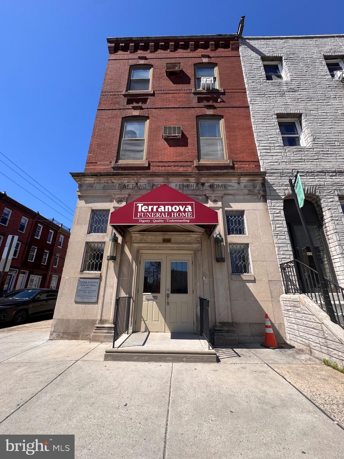 Exceptional South Broad Street opportunity on a prominent corner lot with strong visibility, scale, and multiple potential paths for repositioning. Located along one of Philadelphia’s most recognizable corridors, this property offers investors and developers the chance to transform a highly visible asset in a sought-after urban location.
The ground floor is currently operating as a funeral home and will be decommissioned by the seller in preparation for sale, offering a more straightforward transition for the next owner. The finished basement provides additional functional square footage with high ceilings and plumbed bathrooms. The upper two floors are currently configured as a single residential unit and are leased month to month, with the tenant preparing to vacate in the near future, creating added flexibility for redevelopment or reconfiguration.
The property is served by central air conditioning on the first floor and basement level with window units in the second and third floors. Mechanical systems include an above-ground oil tank fueling an oil furnace for the upper floors and a newer gas-fired furnace servicing the basement and first floor. A newer roof, installed within the last five years, covers approximately three quarters of the structure, excluding the rear section. An abandoned underground oil tank beneath the basement floor has been emptied and capped, and should be further investigated by buyer.
A major value driver is the Wharton Street frontage, where a three-car-wide curb cut, existing two-bay garage door, and loading dock double man door present the likely opportunity to create three-car indoor parking, a rare and meaningful advantage for future residential or mixed-use planning. The property also includes an open deck over the garage and offers sweeping skyline views, including a direct sightline to Billy Penn.
For a buyer with vision, this is a rare chance to acquire a corner asset with strong bones, meaningful square footage, parking potential, and iconic South Broad Street presence.