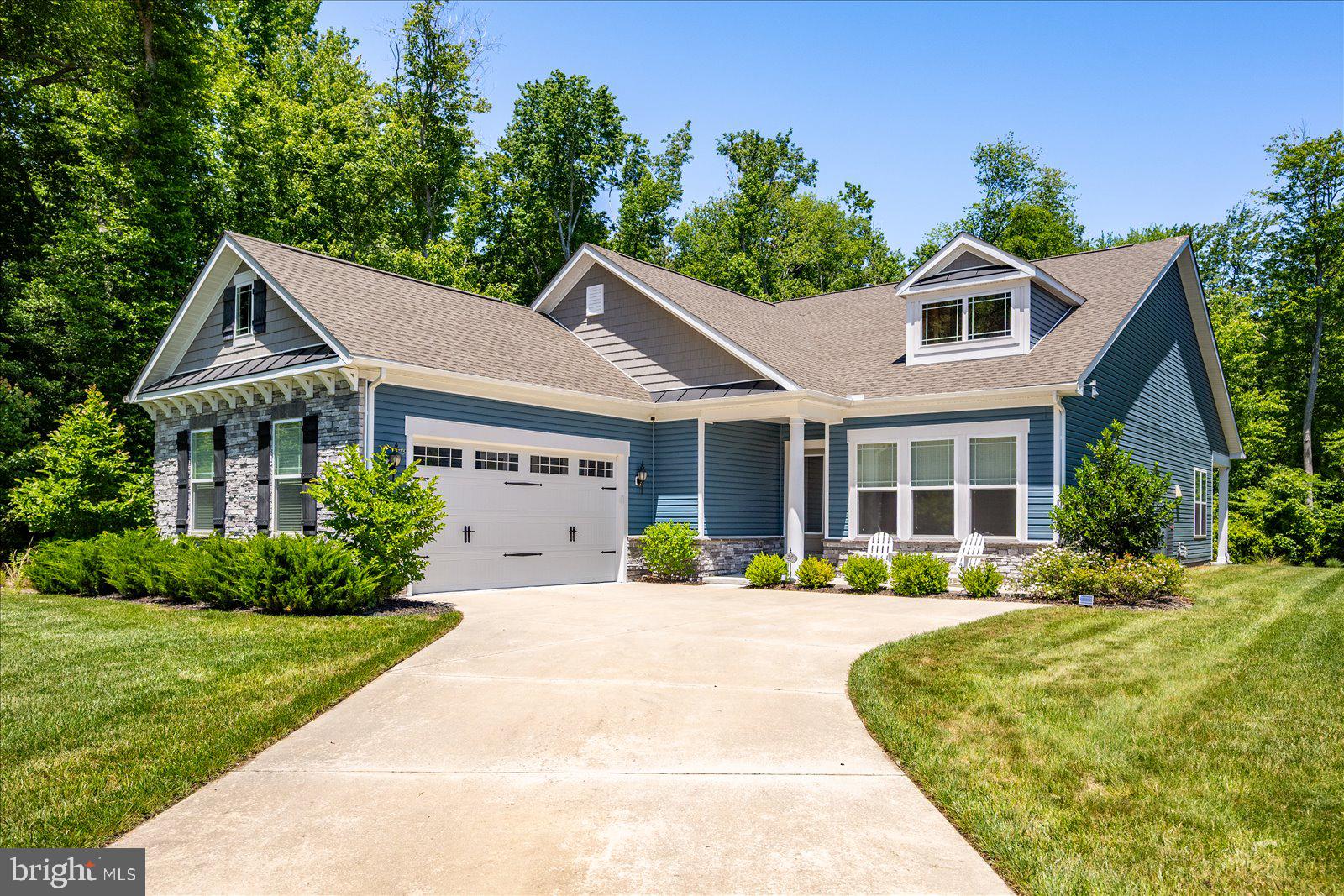 Coastal living at its best located in the sought after community of Ocean View Beach Club. This award-winning Lewes I model home offers an open floor plan, 3 nice sized bedrooms, 2 full bathrooms and 1 half bath. Gourmet kitchen with walk in pantry with shelving. Separate 7’ butler’s pantry/wet bar with quartz countertops, under-cabinet lighting, and soft-close cabinets. Oversized quartz island with plenty of seating and a double sink. Stainless steel appliances which include a double oven, built in microwave and a new LG dishwasher. Gas 5 burner cooktop. Plenty of counter and cabinet space. Timeless backsplash. Coffee bar. Spacious living area/great room with gas fireplace and floating shelves. Living area opens up to dining space. This floor plan offers additional space for a separate living area or dining area. Luxurious primary suite with 2 nice sized closets. Spa inspired primary bath includes large, tiled floor to ceiling walk-in shower and granite countertops. Dual vanities and sinks. Beautiful ceramic plank flooring in the bathrooms. Second and third bedrooms offer big closets. Large mudroom with a GE front load washer and dryer, utility sink and more cabinet space. New England inspired exterior home with stack stone feature. This home offers generous outdoor living space that includes a large, covered lanai style back porch with ceiling fan, recessed lighting and front porch. Two car side garage with shelving units, extra Refrigerator/Freezer in garage, and a service/pedestrian door leading to the side yard and private outdoor shower with custom paver platform. Plenty of off-street parking. This home offers an abundance of storage including a 7’ x 6’4” walk-in storage room. Interior timeless features include luxury vinyl wide plank flooring throughout, custom paint in all the bedrooms and bathrooms, custom window treatments include Hunter Douglas shades, and plantation shutters. Custom light fixtures and ceiling fans throughout the home. Dimmer-controlled recessed lighting. Crown molding and wainscoting. Smart home features include a Google Nest thermostat and a 7-zone Rachio irrigation system, along with solar landscape lighting. Leaf Filter gutter protection includes a lifetime transferable warranty. This beautiful home is located on a cul-de-sac on a premium lot. This lot offers privacy and a beautiful setting. Lushly landscaped. Great home for entertaining family and friends.  One level living. The home has been meticulously maintained and cared for. Ocean View Beach Club offers resort-style living and amenities including large outdoor pool and newly added indoor pool, beach shuttle, state-of-the-art fitness center, pickle ball, game room and event/social gathering area. Great location within the community and an easy walk to the pools, clubhouse, health club-style fitness center, sports courts and beach shuttle. Friendly sidewalks and lushly landscaped community. Biking distance to the beach and close proximity to nearby kayak launch. Close to attractions, local eateries, shopping, water activities, fishing, beautiful State Parks, marinas, nature trails and golf links. Less than 2 miles to Bethany Beach.