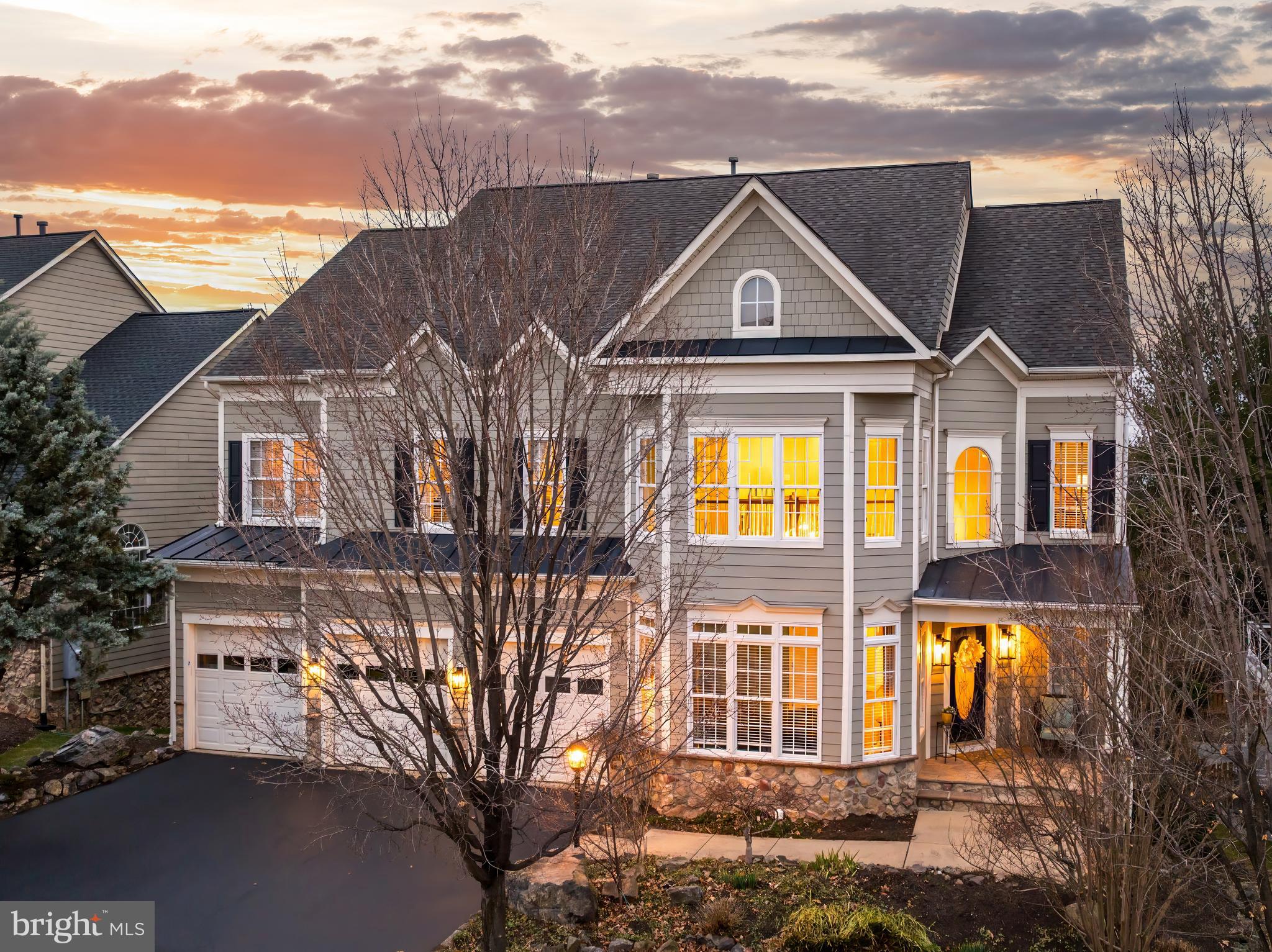Open House Saturday March 29th 2-4pm** A home designed for comfort and the way you live. Located in sought-after Lansdowne on the Potomac, this highly upgraded property blends airy interiors with luxurious finishes, outdoor living, and generous bedrooms with private baths. The exterior welcomes with traditional architecture, highlighted by decorative gables, shutters, and a covered entry. Inside, a grand foyer and two-story living room impress with soaring ceiling heights and south-facing bay windows that fill the space with natural light. The main entryway features a convenient walk-in closet added 2021. Elegant moldings and hardwood floors (updated throughout stairs, hallways and bedrooms in 2023) flow into the formal dining room, well-suited to both large-scale entertaining or relaxed evenings. The kitchen, completely renovated in 2022, appears straight out of a design book: quartz countertops, high-end cabinetry, and contemporary lighting complement a suite of high-end appliances including Bosch refrigerator, Thermador cooktop, GE Advantium convection microwave, dual convection wall ovens, and a wine/beverage fridge. Home chefs will love the bonus storage pantry, pot filler faucet, and the farmhouse sink and additional prep sink. A large center island invites casual bites and conversation. Flow into the open-concept family room, remodeled in 2022 with an updated fireplace, custom surround, hearth, and lighting, or move directly outside onto the deck with versatile options for outdoor enjoyment. Enjoy a large sunny deck, a covered dining area, and a screened three-season room with ceiling fan, all backing to tranquil tree views with stairs leading down to your spacious fenced backyard and upgraded patio. Returning to the main level, you'll also find a large private office, updated powder room, and a chic renovated mudroom serving up storage and style on the way to the garage. Upstairs, retreat to your primary suite featuring tall tray ceilings and extensively remodeled walk-in closets with professional organizers. Part of the primary bedroom was converted to create a versatile office/nursery space, with the dividing wall pre-framed for future french doors if desired. Completely reimagined in 2023, the spa-like primary bath includes a double vanity, freestanding soaking tub, and custom 4-head shower. Two additional bedrooms with walk-in closets share a remodeled Jack-and-Jill bath, and another bedroom suite enjoys its own private full bath newly remodeled in 2024. A convenient laundry area with upgraded front-loaders is located nearby. The fully finished and extensively remodeled lower level greatly expands your living space, with hardwood stairs leading down to designer tile flooring throughout. A daylight recreation room features a kitchenette with full-size refrigerator, opening directly onto the patio and yard through sliding doors. The basement renovation included an updated full bathroom with custom shower and fifth legal bedroom to create a private suite. Two flexible bonus rooms on the lower level include a dedicated exercise room with Tonal workout system, perfect for fitness, play or hobbies. The home offers the convenience of two laundry areas, with additional machines in the lower level utility/storage room. Additional updates include: durable Hardie-plank and Hardie-shake siding, window replacements, below-grade drainage improvements, a whole-house water filtration system, and a new upper-level furnace/air handler in 2022. Life in Lansdowne unlocks exceptional community amenities, including indoor heated and outdoor pools, a fitness center, playgrounds, sport courts, business center, ballroom, meeting rooms and more. Enjoy easy access to Route 7, nearby shopping and dining at Lansdowne Town Center, as well as Lansdowne Resort & Spa, Golf Club at Lansdowne, hiking trails and Elizabeth Mills Riverfront Park. This property effortlessly balances modern style and everyday comfort. Welcome home!