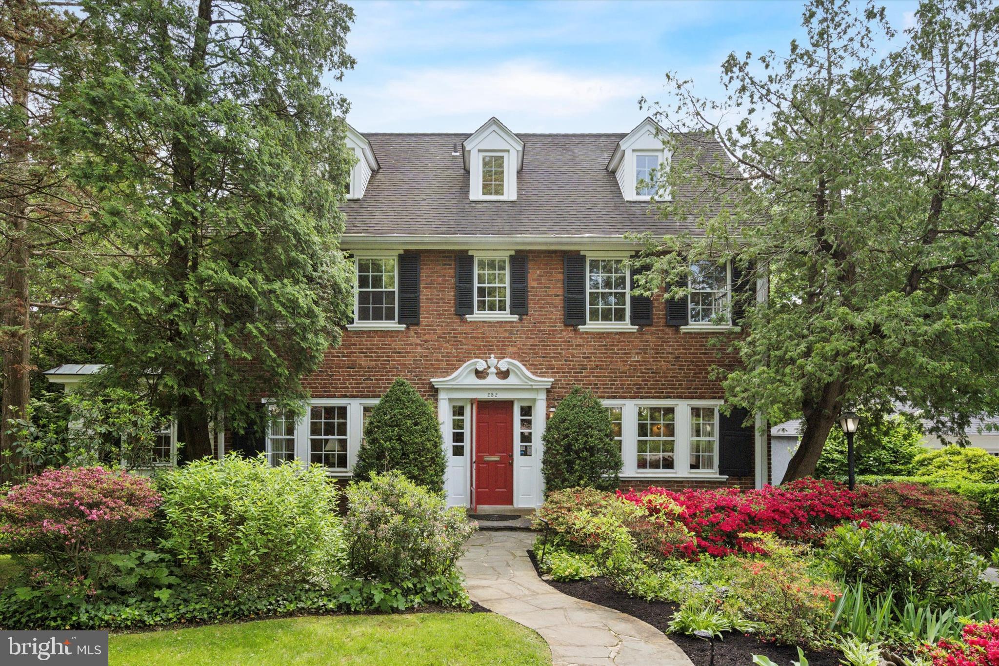 Interior photos are now available. Be sure to watch the full motion video.  Welcome to 252 Hathaway Lane—a classic center hall Colonial nestled in one of Wynnewood’s most desirable neighborhoods and zoned to the award-winning Lower Merion School District. Set along tree-lined streets with sidewalks in every direction, this charming home with large backyard and mature gardens offers the perfect blend of timeless appeal, everyday functionality, and unbeatable walkability.

With both the Wynnewood and Ardmore SEPTA stations just a short walk away, commuting to Center City or exploring nearby suburbs is effortless. Just beyond your doorstep, enjoy all the Main Line has to offer—Trader Joe’s, Whole Foods, Suburban Square, Lower Merion High School, and the vibrant boutiques and eateries of downtown Narberth. Even the beloved Narberth playground and community events are just a sidewalk stroll away.

Step inside to a gracious foyer with a recessed staircase that sets a welcoming tone. To the left, a sunlit formal living room with a gas fireplace provides an inviting space to unwind. Just beyond, a bright and flexible sunroom offers endless possibilities—ideal as a playroom, music room, home office, or even a private professional practice space, thanks to an existing zoning variance and separate entrance.

To the right of the foyer, a formal dining room flows easily into the eat-in kitchen, creating a great setup for everyday meals or holiday entertaining. Tucked behind the kitchen, a spacious family room addition serves as the heart of the home, with two full walls of built-in bookshelves and storage. From here, step outside to a flagstone patio and an expansive, flat, fenced-in yard—perfect for summer gatherings, kids at play, or simply enjoying the outdoors.

Upstairs, the second floor offers a primary suite with three closets, built-in chests of drawers, and a private en-suite bath. Two additional bedrooms and a full hall bath complete this level. The third floor features two more charming bedrooms—each with built-in shelving—and another full bathroom, ideal for guests or flexible living arrangements.

The basement provides laundry, ample storage, and room for a workshop as well as a darkroom. Outside a 22KW whole house generator (for stress free storms), a detached two-car garage and generous driveway parking complete the package.

Lovingly maintained by the same family for nearly half a century, this beautiful home is full of potential and ready for its next chapter. With its prime location and gracious layout, 252 Hathaway Lane is a rare opportunity you won’t want to miss. Estimated sqft is from a certified appraiser, but buyers should always verify as needed.