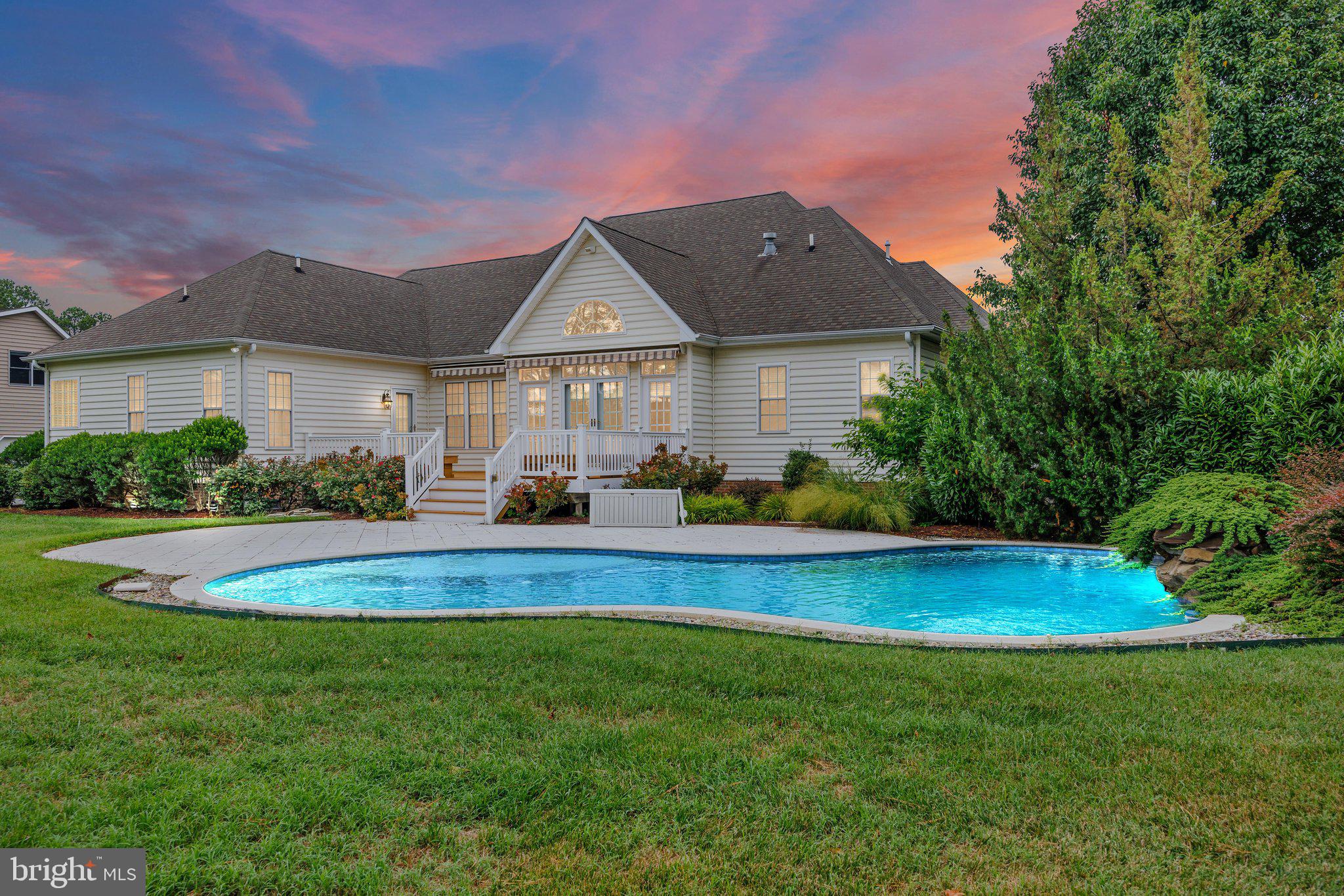 WATERFRONT LIVING on Winchester Creek! This wonderful 4 bedroom, 2.5 bath Grasonville estate offers the ultimate Eastern Shore lifestyle, fully refreshed with a newly painted neutral interior, gleaming refinished hardwoods, and carpet. A grand 2-story foyer with a palladium window, transom accents, and elegant French doors welcomes you inside. The main level features 11' ceilings, a great room with fireplace and a bank of windows with water views, a separate dining room, bright breakfast room, and a fabulous kitchen with an island, pantry, and reverse osmosis water filtration. The main floor primary suite boasts a walk-in closet and a no-threshold shower, complemented by a full, hall bath and convenient half bath. Upstairs, a versatile bonus space features custom built-ins— perfect for an office and media space. Your outdoor resort awaits: a Trex deck with built-in benches and retractable awning leads to a custom paver patio and a sparkling 18’ x 37’ saltwater pool with a tranquil waterfall feature. Boaters will love the deeded boat slip (#10), mooring pile, and private boat lift. Rounding out this incredible home is an oversized 2-car garage with storage space, HVAC (2018), buried 500-gallon propane tank, and full water conditioning system and lush landscaping.