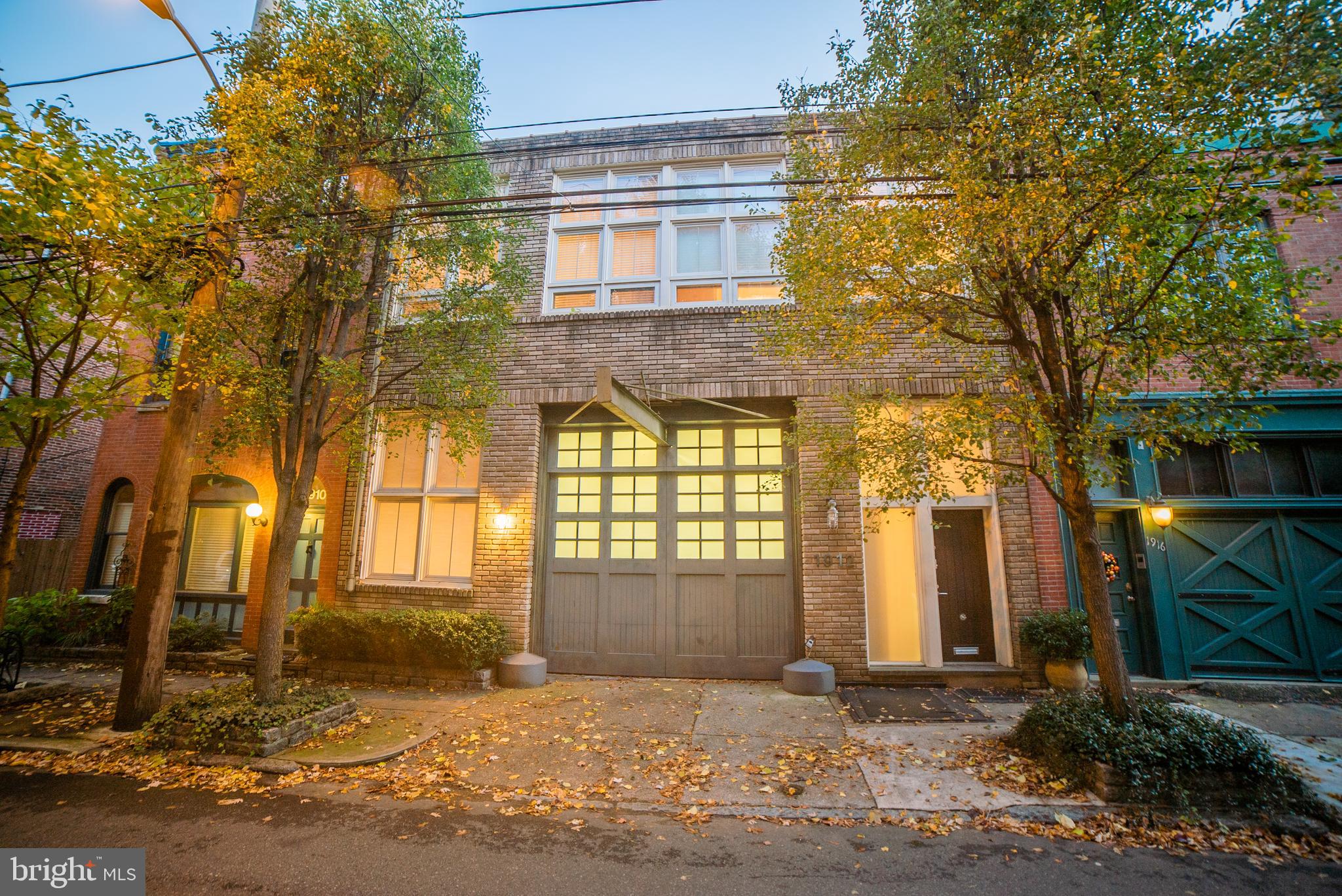 Exceptional double-wide carriage house in a prime location, the ultimate live/work configuration. This light-filled, 4,480 square feet home with a garage, and roof deck has an open floor plan and is located on a quiet, tree-lined block. The first floor includes slate floor entry with access to a double-wide studio/workspace with a full bath, garage, and office. The second-floor open floorplan includes a living room, dining room, two bedrooms divided by a custom wall of steel-frame shoji doors; 15-foot ceilings, designer lighting, and white oak floors. It also features a full bath, two sinks, and a walk-in travertine-lined shower. The modern kitchen features concrete countertops, a farmhouse sink, and ample cabinet space. Pull-down stair accesses partial attic. A spiral stair leads to a stunning Ipe deck with panoramic city skyline views that traverses the entire roof. On the roof are established planters and a full watering system. This property is a rare gem with myriad design and configuration possibilities and is within walking distance of the best Philadelphia has to offer. Ready for immediate occupancy.