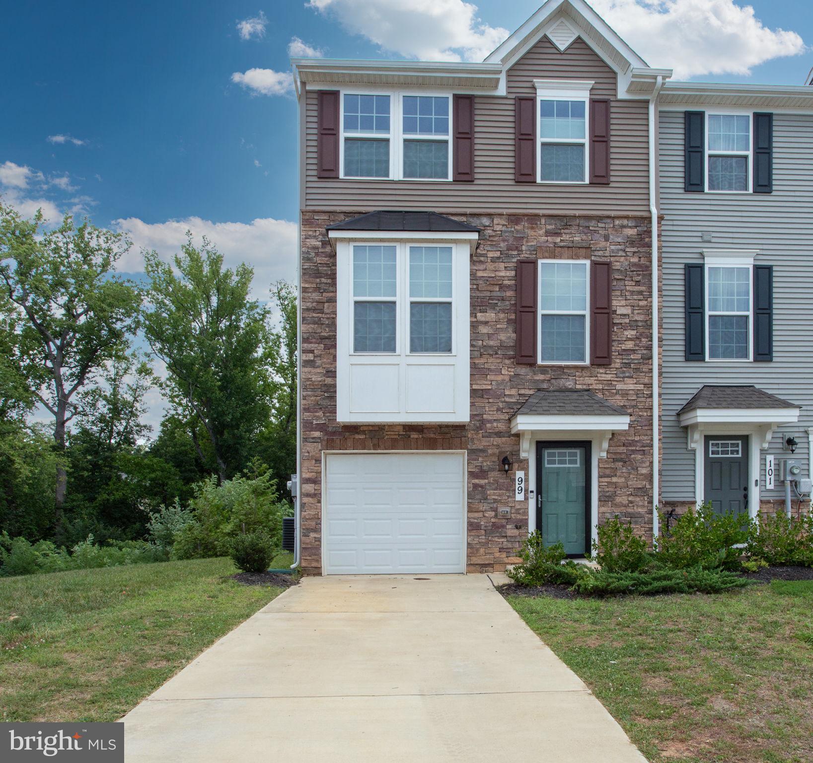 Built in 2022, this beautifully maintained end-unit townhome in the sought-after Anchor Point community offers the perfect blend of modern design, comfort, and convenience. Featuring an attractive stone front, an attached garage, and plenty of additional nearby parking, this home is ideally located within walking distance of the NSWC Main Gate, local restaurants, parks, shopping, the Indian Head Center for the Arts, and the Indian Head Rail Trail. Commuters will appreciate the easy access to Route 210 for travel to Washington, DC, and Northern Virginia. The spacious floor plan is filled with natural light and offers over three finished levels of thoughtfully designed living space. Beautiful luxury vinyl plank (LVP) wood flooring extends through the foyer, staircase, and entire main level, creating a warm, cohesive feel. The main level is perfect for everyday living and entertaining, featuring a stunning kitchen with a large center island, quartz countertops, stainless steel appliances, built-in microwave, pantry, and generous dining area that flows seamlessly into the expansive living room. A convenient powder room completes the main level. Step outside to the private rear deck and enjoy peaceful wooded views. Upstairs, the luxurious owner's suite features an elegant tray ceiling, a large walk-in closet, and a private spa-inspired bath with a double vanity and oversized shower. Two additional spacious bedrooms, a full hall bath, and room-darkening blinds throughout provide comfort for family and guests alike. The finished lower level adds exceptional flexibility with a spacious recreation room, additional storage and walkout access to the fully fenced backyard. Backing to mature woods, the outdoor space offers both privacy and a serene natural setting. This move-in ready home combines modern finishes, abundant living space, a premium end-unit location, and one of Indian Head's most walkable neighborhoods—making it an exceptional opportunity for homeowners seeking both convenience and lifestyle.