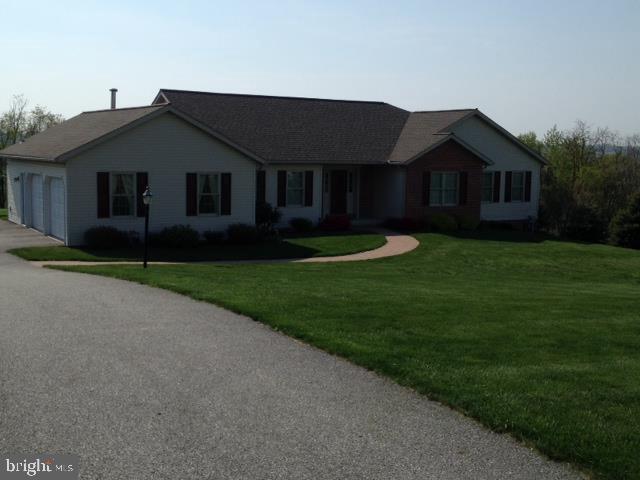 Welcoming, well constructed rancher on 1.8 acres, like new condition! From the hardwood foyer to sun room w/awesome view this home is quality throughout. Features include custom cherry cabinets, spacious laundry, MBR w/walk-in, 4th BR/Den in walk-out basement, lawn equip garage/workshop & generous storage. Enjoy sunsets and nature!