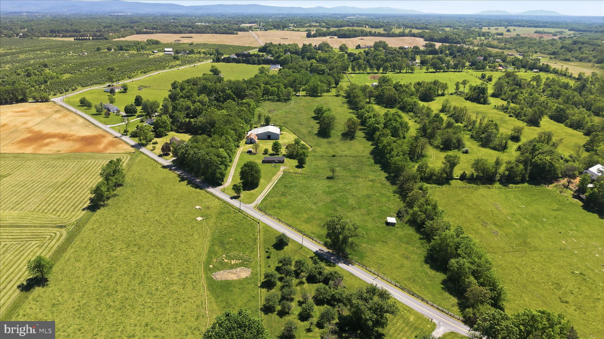 Minutes from The Virginia line for an easy commute, we are proud to present this 14.2 acre Farmette outside of the historical and quaint village of Summit Point. Sitting at the end of a long private driveway, is where you'l find this all brick 1600 sq. ft. renovated home with 3 bedrooms and 2 full baths. The owners have lovingly and tastefully installed new kitchen cabinets, stainless appliances, LVP and unique ceramic tile. The whole house is freshly painted and ready for immediate ocupancy. The Exterior of the home has a brand new architectural shingle roof, new windows, gutters and more. 
  This property can be subdivided with a total of 3 lots.  That includes the existing home and buildings. As you look around you, you will be delighted with the 4 board fenced fields, panoramic views, run-in sheds and  stable and  an approx. 70 x 70 indoor arena in the distance.  All together, there are 23 oak lined stalls and a tack room and feed room. Excercize your horses in inclement weather in the cozy indoor arena with 20+ ft. ceilings that have skylights to let the sunshine in.  This property adjoins other farms and could provide you some ride-out on neighboring properties. 
  The Famous Charles Town Horse Racing Track is less than 20 minutes away. Being so close opens up many options for horse boarding, giving race horses a place to relax and heal, breeding, training and more.  Being zoned Rural and Farm makes this property perfect for any type of animal  you might want to raise. The zoning will also allow for a farm market and other related cottage agricultural industries.  Some might require a permit and zoning approval.
   Whether you want to get off of the grid, have a family farm or start a cottage business, this one of a kind home and property will be just what you are looking for.