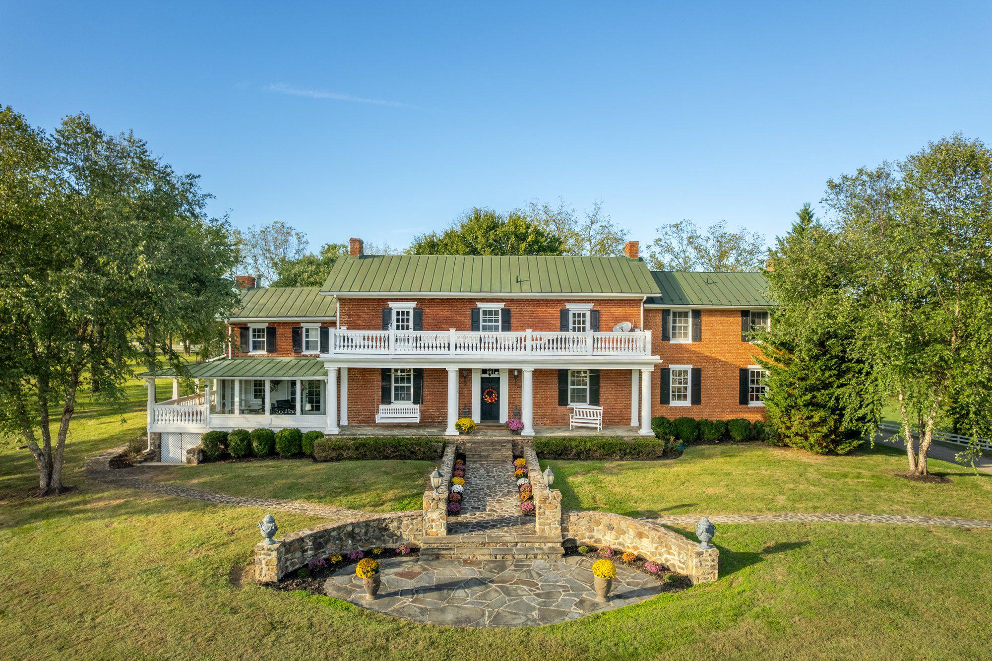 Seaton Place Farm — A legacy estate of scale, privacy, and distinction in the heart of Hunt Country. Back on market through no fault of the property or sellers. Originally under contract as a secondary country retreat, the buyers' circumstances and timing changed. Inspections were completed successfully, and the reports are available upon request.

Set between Upperville and Delaplane, on the edge of coveted Mellon land and within Piedmont Hunt territory, this 55± acre estate represents a category of ownership rarely available—and increasingly impossible to recreate. Defined by land, location, and architectural presence, it offers a level of privacy and permanence that distinguishes it from typical offerings.

The circa-1840 brick residence—spanning approximately 5,800 square feet—has been carefully evolved to meet modern expectations while preserving its historic integrity. Positioned to command the landscape, the home is surrounded by curated outdoor environments including formal stone courtyards, a koi pond, a marble and wrought-iron rotunda, and a pool designed for both entertaining and retreat.

Interiors are grounded in authenticity yet executed with refinement. Original materials—exposed brick, antique flooring, hand-blown glass, and period mantels—are complemented by elevated updates and a cohesive design approach. The primary suite offers privacy, natural light, and elevated views across the property, reinforcing a sense of quiet separation from the everyday.

A newly reimagined kitchen and great room anchor the residence with a distinctly modern luxury sensibility. Featuring an imported Lacanche range, bespoke cabinetry, premium appliances, and a cathedral ceiling framed by a substantial stone fireplace, the space delivers both visual impact and functional excellence. Published and thoughtfully designed, it is the true center of the home.

A separate carriage house introduces flexibility without compromise. Fully independent, with three bedrooms, two baths, and a complete kitchen, it functions equally well as a guest residence, staff quarters, or income-producing asset. Its established record as a highly rated luxury rental underscores both its quality and appeal.

The estate’s amenities extend beyond expectation.

A private Par 3 golf course—with three professionally designed greens and eleven tee boxes—offers a rare, low-maintenance recreational asset. A substantial pond with dock, an established barn complex, and extensive supporting infrastructure position the property for equestrian use or broader lifestyle pursuits.

The barn includes six stalls with individual run outs, a wash stall, dual tack rooms, loft storage, and flexible auxiliary space suitable for modern adaptations—fitness, storage, or collection use. Additional features include fenced pastures, run-in sheds, a creek-fed field, greenhouse, garden, and supporting agricultural structures—creating a fully realized estate environment.

This is a property that operates at a different level.

Private, complete, and inherently limited by geography and legacy land constraints, Seaton Place Farm offers a compelling opportunity for the buyer seeking scale, discretion, and long-term value in one of Virginia’s most established and tightly held regions.

A refined Hunt Country estate—offered for those who understand the difference.