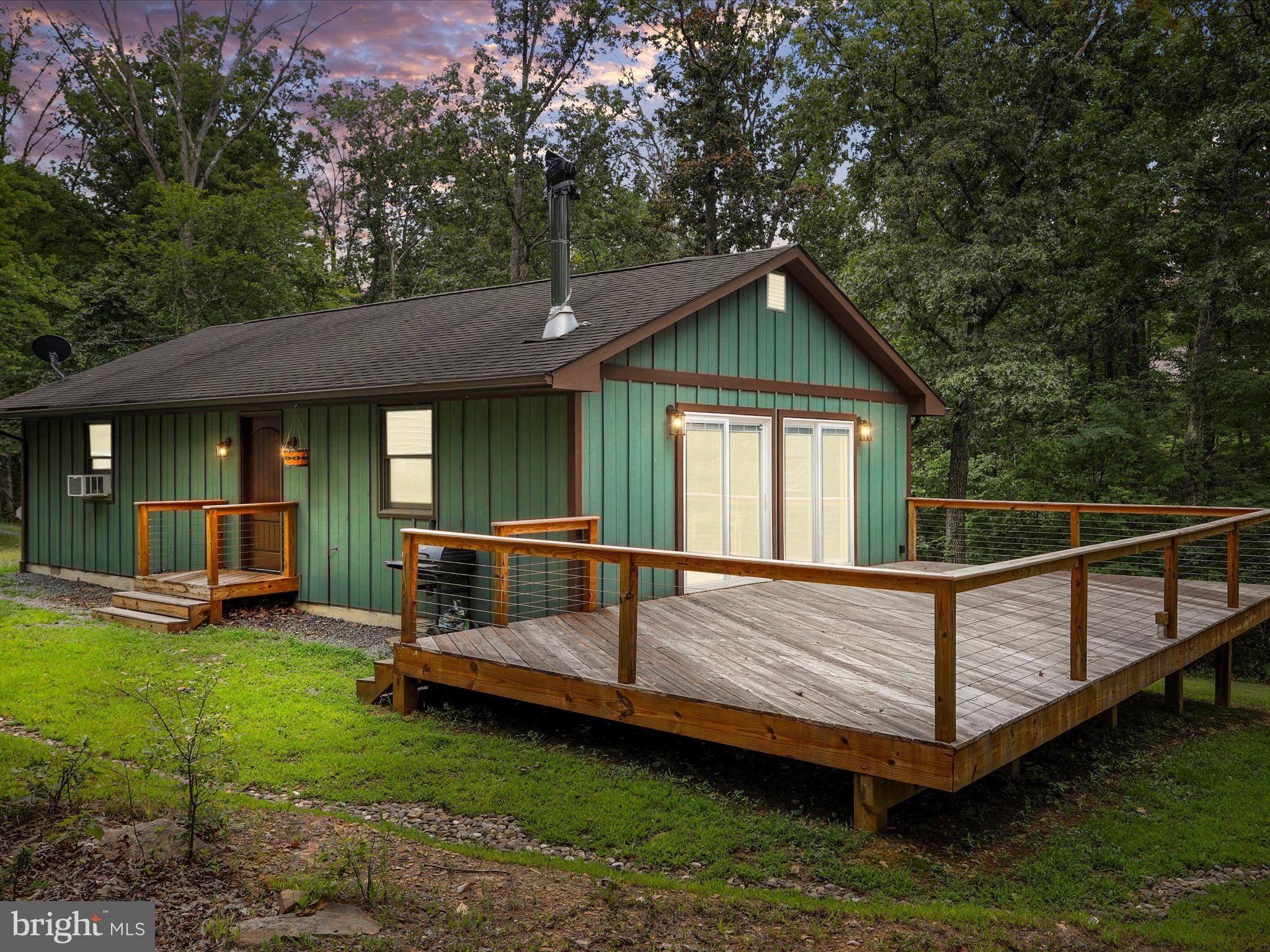 Private Custom Ranch on 7.63 Acres Bordering 400+ Acres of Wildlife Management Land
Tucked away at the end of Teals Lane, this beautifully crafted custom ranch home offers the perfect blend of privacy, comfort, and natural beauty. Surrounded on two sides by the Widmeyer Wildlife Management Area—with over 400 acres of protected land full of whitetail deer, wild turkey, and black bear—this property is a dream for nature lovers and outdoor enthusiasts. Forest trails lead down the woodland Hills to the Potomac River for hiking and exploring.
Inside, you’ll find rustic white oak floors throughout, tongue-and-groove knotty pine walls, and an open floor plan. The eat-in kitchen features concrete countertops, solid wood cabinetry, recessed lighting, and a double sink. The spacious living room offers a native stone hearth with woodstove and two sliding doors opening to a large 31x16 deck with low-maintenance steel cable railing.
The home includes two relaxing bedrooms, a cedar-accented bathroom with granite counters and a full shower, and a laundry room with  stacked washer/dryer and extra storage. Central propane heat, new PEX plumbing, excellent insulation, and a climate-controlled, encapsulated crawl space keep the home comfortable and efficient year-round.
Exterior highlights include newer board-and-batten siding, a 20x30 metal garage, solid shale driveway base, reinforced culverts, French drains, and mature oak trees. Fiber internet is available. This peaceful retreat is perfect as a full-time residence or a second home getaway.
Come home to a place where nature, comfort, and privacy come together—your own peaceful escape from the everyday.
