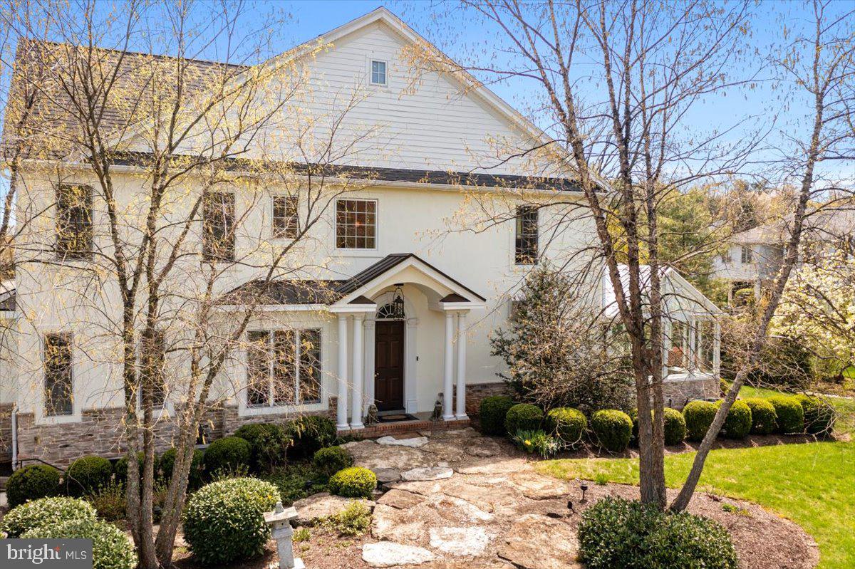 Nestled in picturesque Saucon Valley, this magnificent 5500sf residence embodies luxury living and is the epitome of timeless elegance. Lush landscaping, verdant lawn and long-distance views envelop the property, providing both privacy and tranquility. Exceptional architectural and design elements like high ceilings, rich random-width pine floors, incredible detail moldings, high-end finishes, and an abundance of windows all combine to create an oasis of sophisticated living. The flow is superb. The greeting and dining room with 10-foot ceiling, Brunschwig & Fils wallpaper and marble surround FP is ornamented with formal molding and custom window treatments. The Federal ambiance continues into the library, the perfect spot for pensive solace. With a nod to Nappa Valley, the living room is stunning with its 18-foot vaulted ceiling, trussed beams and curved corbels. The white oak paneling and cut-stone gas fireplace exudes warmth. Acoustically designed and defined by stone walls, the music room has a 13-foot coffered ceiling. The open kitchen is designed for efficiency and functionality. Cooking options are numerous with a S/S Gaggenau steam/convection oven and S/S TM10 Intelligent double ovens with refrigeration to keep your delectable dish chilled until the timer turns on the cooking. The 48” Wolf gas cook top has infrared grill, pot filler, 1600 cfm hood, and Dacor warming drawer. The cappuccino center has its perks, as do the Fisher Paykel 2-drawer D/W and undercounter Sub-Zero refrig/freezer drawers. Detailed wood cabinetry offers an astounding array of storage. Another highlight is the 2-story English style mahogany conservatory with UV protection glass panels. This structure includes the breakfast room with garden views, and the indoor courtyard. Dramatic turned staircase leads upstairs and down or take the elevator which services all three levels. The second floor offers a large landing with coffee station-wet bar, laundry room, and three distinctly private en suite bedrooms, each with WIC. The primary bedroom is stylish with tray ceiling, crown molding, chandelier, faux painted walls, and dressing room with large WIC. The bathroom is fully renovated and a testament to luxury with hand-painted walls and chandelier. Luxuriate under double rain shower heads and hand-held sprayers in the large glass shower or enjoy an indulgent soak in the serene slipper tub. Double vanity, beautiful tile work, separate water closet and another WIC are added features. The two guest suites offer similar elegance, and the bathrooms have glass showers and heated ceramic tile floors. Descend to the lower level, with floors of brick tile, to enjoy entertainment and fitness. The spacious family room with coffered tray ceiling is ideal as media room and through double pocket doors is the large wet bar with granite counter, double sink, two U-Line beverage cooler drawers and bar refrigerator. For the active lifestyle, the exercise room with cork floor looks through to the courtyard with stone walls and brick gas fireplace, and heated hydrotherapy saline pool, ideal for low-impact exercise and rejuvenation. This lower level offers flexibility for multi-generational living and aging in place, with a fourth bedroom and separate entrance via heated brick stairs. There is a large full bath with sauna shower and heated floor. The garage has excellent storage, pet wash station and car lift, adding a third parking spot. Fine dining and shopping are nearby, as are the Lehigh U. athletic fields offering opportunities for recreation. Explore close by Water Street Park, which hosts a farmer's market during summer and connects to the Saucon Rail Trail. Saucon Valley CC is 3 miles away. Experience maintenance-free luxury living where elegance, comfort, and convenience converge…and make this exquisite property your own!