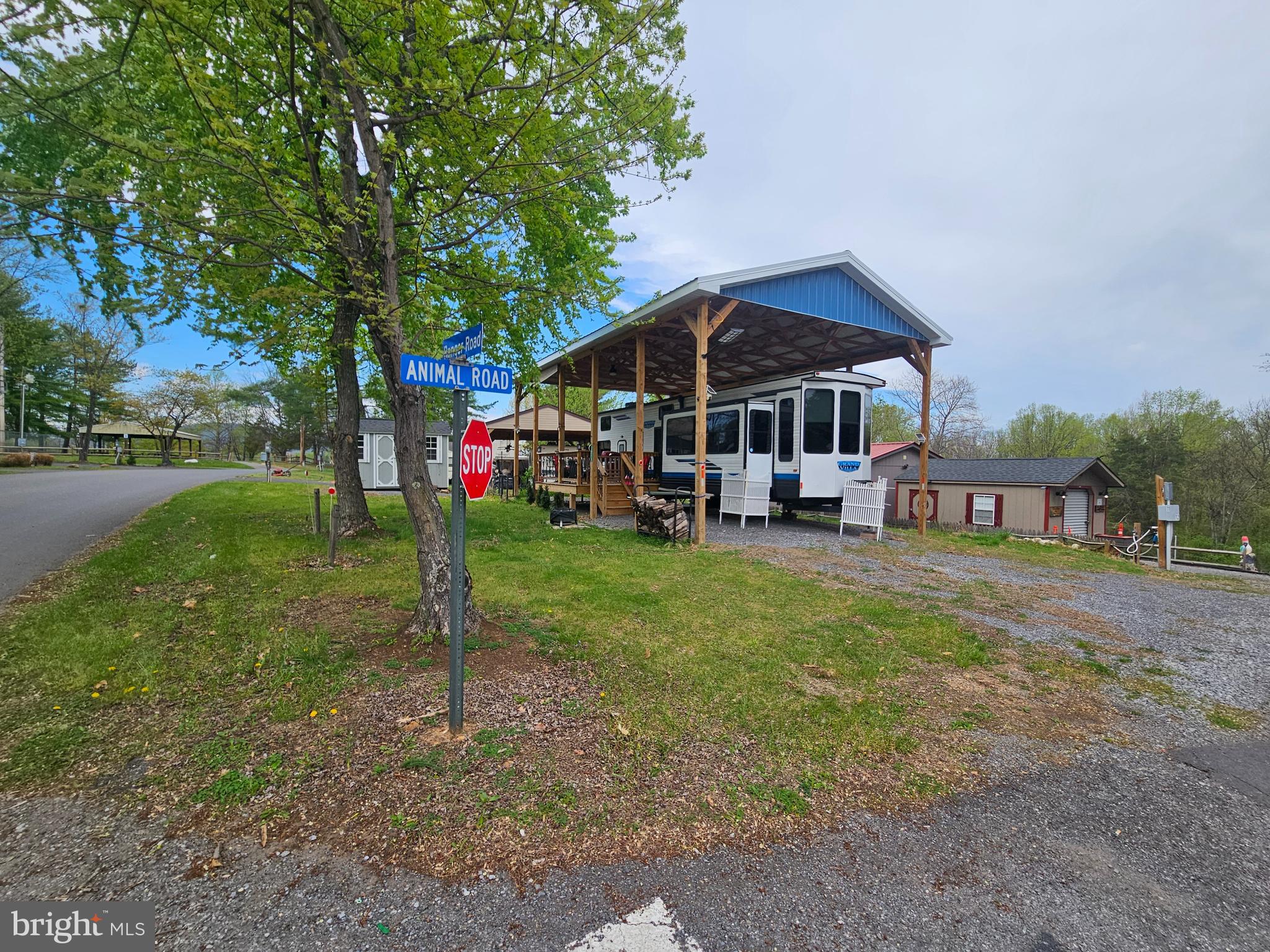 Welcome to Block 26 lot 11 Ranger Rd sitting on a flat corner lot on SEWER in Riverbends Rv Campground. Riverbend is 400 Acres of SEASONAL recreational campground full of amenities located on the Potomac River in Falling Waters, Wv. OPEN APRIL 1 - NOVEMBER 1 - This is a fun & entertaining community, yet relaxing. This lot is highly desirable featuring a large stick-built pavilion with a
Situated on a cleared corner lot on SEWER is your newly stick built (Heavy Duty) Pavilion with a metal roof, 6 * 6 posts, electrically wired with led lights, patio lights and a ceiling fan to keep that warm summer air moving while relaxing on your 12 * 12 new deck surrounded by the beautiful metal pickets and room to expand if you wish. Attached are pull down shaded to block that sun and give you some privacy. This houses your newer 40 FT 2023 Salem Grand villa with alll the upgrades including a water softening system and a water pressure system. Move right on into this one folks, you'll see the current owner added all the extras and is taking a great loss. Inside you'll find a stunning kitchen, dining and living room combo. The kitchen features Stainless Steel Appliance including a full-size standard French Door Refrigerator, Stove, Oven, counter top toaster oven, Ice maker, countertop Dishwasher all conveying. Everything you see stays! The kitchen island hosts the under counter double sink. The living room has large windows to boast extra daylight and has privacy shades. 2 recliners to kick back and watch the 55 In Fire TV with the Furrion sound system  in front of the electric Fireplace that can be used to look nice or to take the chill off on any cool days. Absolutely no shortage on sleeping places here in this Grand Villa. Pull out couch, Two rooms in the loft area, one has a single twin mattress with a Tv, Dvd player and extra storage and the other loft has TWO Twin mattresses. Where will YOU be sleeping? I am glad you asked, with its own entry or off from the kitchen in the Primary sleeping quarters with a King size bed, dresser space, built in washer and dryer. If you have pets having this own entry door can be convenient to let the pups out into the fenced in yard area. This sweet rig also has Dual A/C units. In the Bathroom you'll find a nice size shower, a standard home toilet with an upgraded Bidet controlled by a remote with ALL the features, The Internet Box Travel Fi can stay but you must sign up for your own account. Stop by and see this one, you're going to love it. 

A Brand-New shed also conveys, sitting on a new gravel pad, it has electric and can fit the golf cart or convert it to a bunk house if you wish.  Picture your 3 seasons with friends and family around the fire pit making memories!
Call today for your personal tour. Approx. 10 miles of Deep water on the Potomac River access for boating, fishing & swimming. Yearly membership ($1,987) plus a $200 initiation fee for new owners, includes water, sewer, electric, trash and the park amenities such as 3 pools, putt putt course, Horseshoe club, Boat club, Poker runs, Trick or Treat, Christmas in July, live bands, basketball court, tennis court, fireworks, car show, Church, restaurant, bar, convenience store (Great food), playground, volleyball, ball field and much much more. Join Riverbend Boat Club. Bring your golf carts, water toys and come enjoy life!
