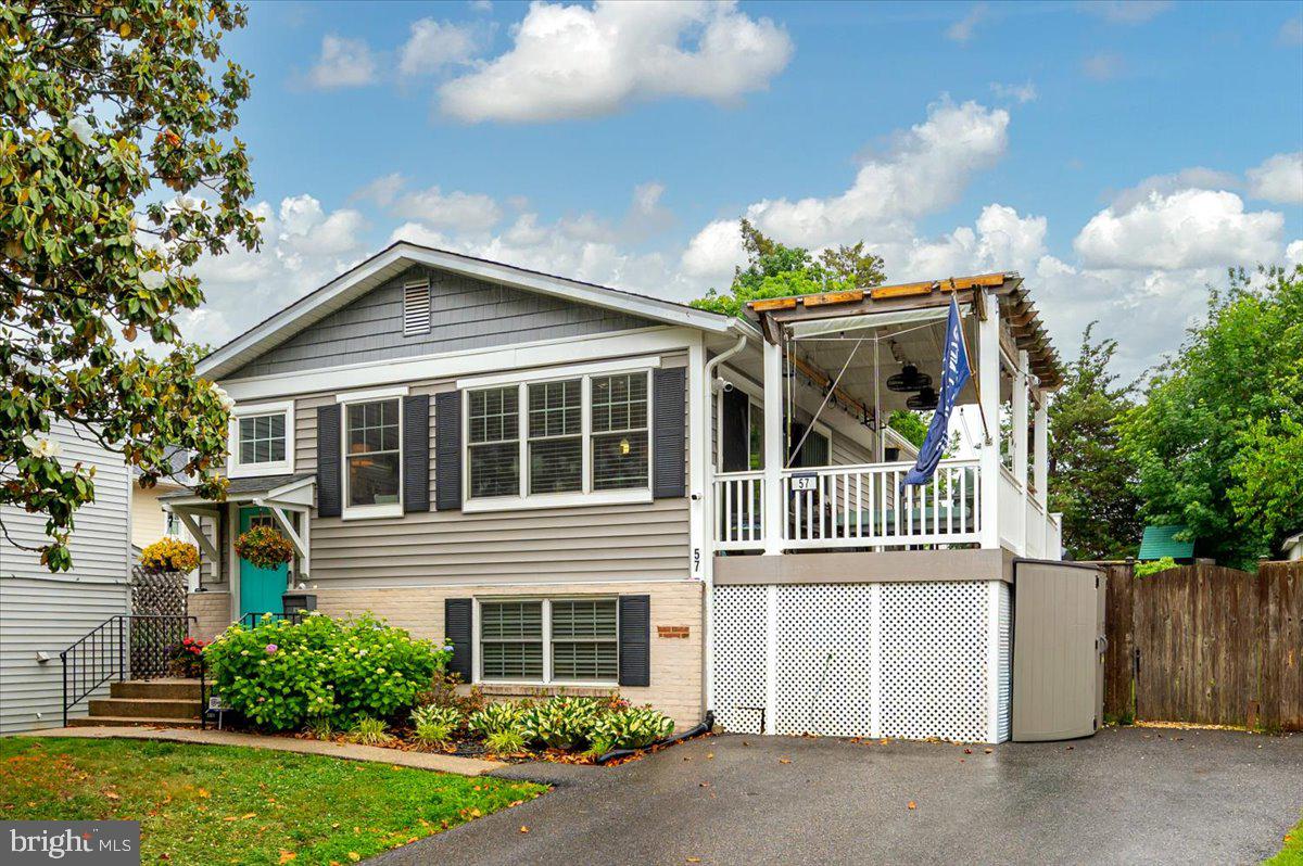 This charming downtown Annapolis home is located in the most desirable neighborhood of Murray Hill. Walk out your door and access everything Annapolis has to offer - restaurants, stores, Naval Academy, Stadium, etc. This property was completely renovated recently. The kitchen offers stainless steel appliances, quartz countertops and engineered wood flooring throughout! The property also includes a large backyard and ample parking - a rare find in downtown Annapolis! As you walk into your new home you will notice the open kitchen/living room area has plentiful lighting with white cabinetry, Kitchen Aid appliances, an island with extra storage, and a subway tile backsplash. The main level also offers two spacious bedrooms and a large deck off of the kitchen with lots of sunlight. The lower level of the home offers the primary bedroom and private bathroom, along with a den area that includes a beautiful brick fireplace surrounded by bookshelves and cabinets, a 1/2 bath and front load washer & dryer! There is  plenty of storage and a door to access the large backyard where you can enjoy the playground & picking crabs while your kids run around in the fenced in backyard! Murray Hill features water access at the end of many streets where it is easy to launch a kayak/stand up paddle board or hop on the water taxi! It is also very close proximity to the Navy stadium which makes walking to the games an easy short walk! Come enjoy the best of Annapolis life in a charming home and the perfect location!