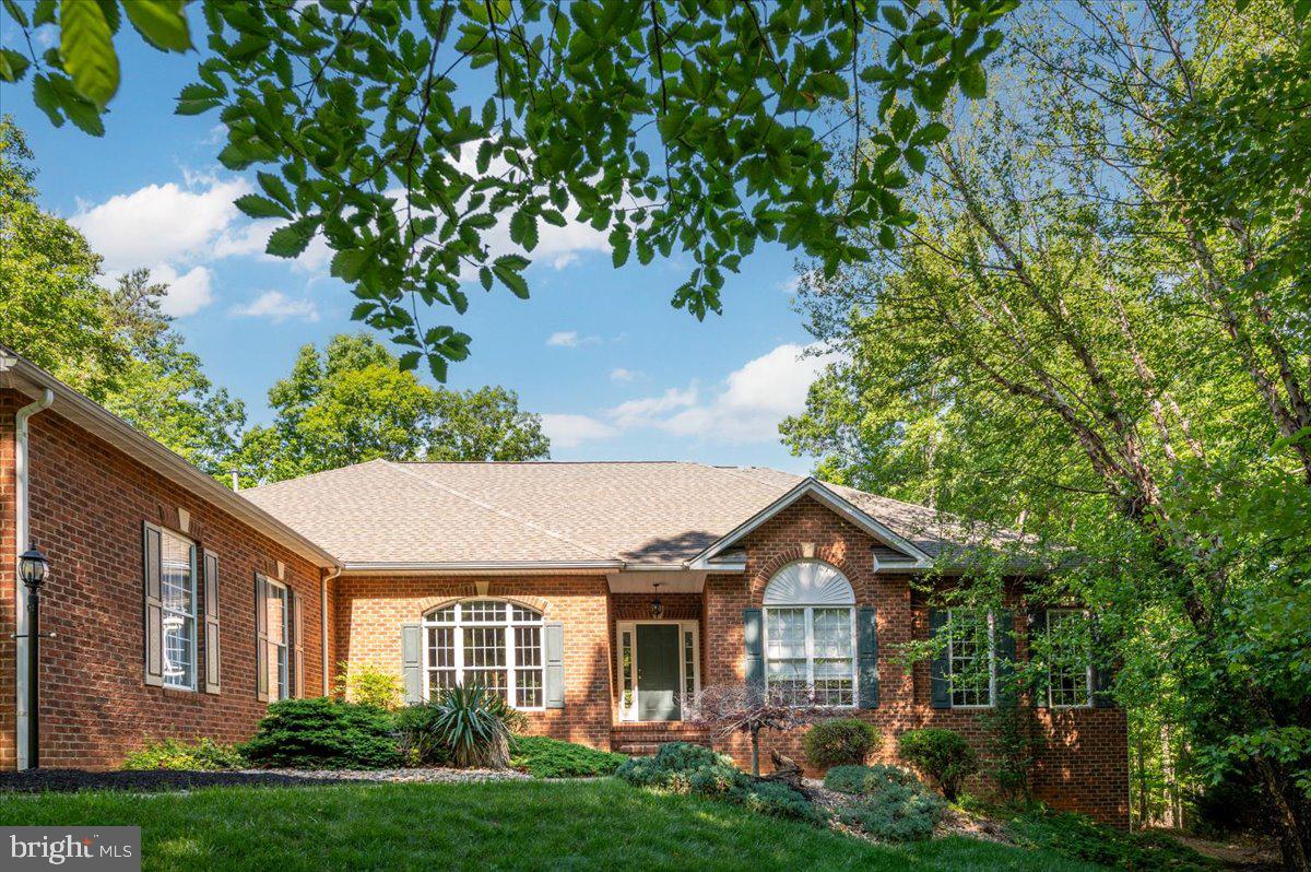 Exceptional custom brick-front rambler in the sought-after Payne’s Farm community, set near the end of a quiet cul-de-sac on nearly 5 private acres. Offering almost 6,000 square feet of beautifully maintained living space, this home delivers main-level living at its finest with the room, privacy, and quality buyers rarely find together.

The open floor plan is warm, spacious, and ideal for both everyday living and entertaining. The main level features a large family room with gas fireplace, a gourmet kitchen with granite counters, ceramic tile backsplash, upgraded cabinetry, and generous workspace, plus a dedicated office for work-from-home convenience. The luxurious primary suite includes a deluxe bath and walk-in closet with custom shelving. Additional bedrooms are generously sized, and all bedrooms include walk-in closets.

The finished lower level is a true extension of the home, featuring a huge recreation area, a stunning wet bar, workout room, two additional bedrooms or flexible-use dens, a full bath, and a workshop. Whether you need guest space, hobby space, media space, or room for multigenerational living, this level offers tremendous versatility.

Outdoor living is equally impressive, with a large Trex deck overlooking the expansive private rear yard, mature landscaping, and peaceful natural surroundings. A whole-house generator adds practical peace of mind. Beautifully upgraded, thoughtfully designed, and exceptionally well cared for, this property offers custom quality, privacy, space, and convenience in one of the area’s most desirable estate-style settings.