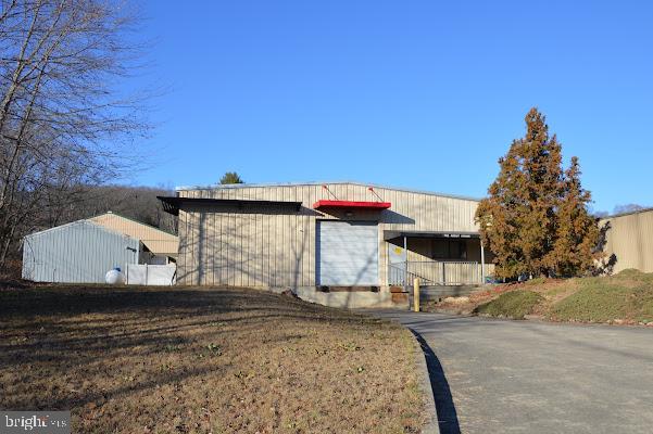 Over 11,000 SF of warehouse/manufacturing space, plus three (3) out buildings.  The Main Building has 4,750 square feet of 16' ceilings with four (4) 14' drive in doors.  Another approximate 1,275 SF of 10' ceiling and another 5,000 SF with 10-12' ceilings with one 14' DID and on 12' drive in door and a loading dock.  700 SF office space.   All warehouse space is heated with propane.  The also has two storage sheds approximately 24' X 100' each and a multiple unit storage facility approximately 150' X 24' with some unites rented.  Plenty of yard space on the 4.96 acre parcel gives you the possibility of future expansion.  The building is inside the Orwigsburg Industrial Park and located ten (10) miles from Interstate 78 and three (3) miles from State Route 61.  Owner is currently excavating the site which will increase the buildable area of the property.  Most of the 4.963 acres is mainly level.  The building is also offered for lease at $6,550.00 per month with normal sewer and water charges ($90.00 month) and real estate taxes capped at $20,055.00 per year.     The 11,000 SF is $4.65 PSF + the estimated real estate taxes, building insurance, sewer and water $2.50 PSF.  Call for details.