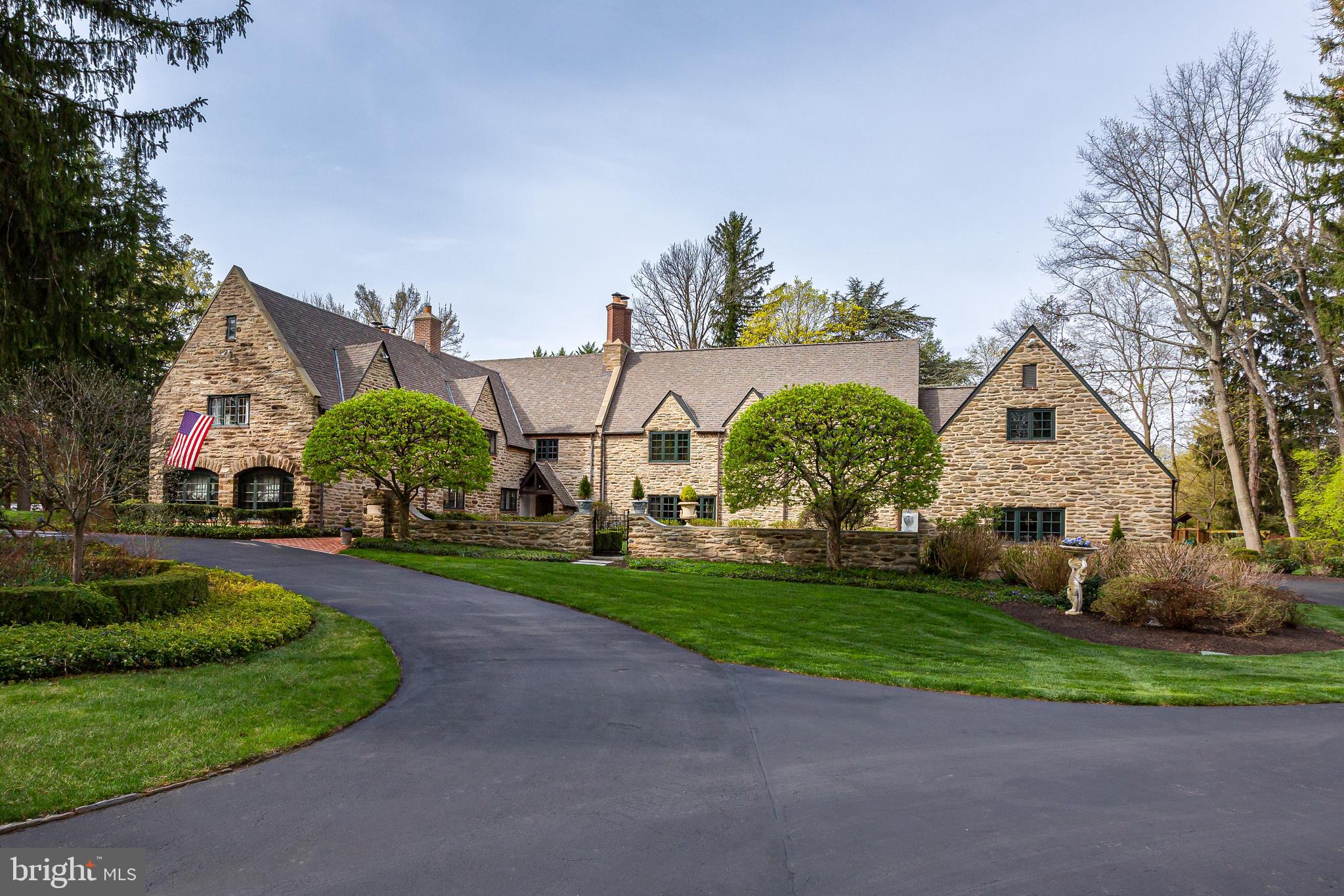 Welcome to Braehead—named for the Scottish phrase “Top of the Bank”—a stunning,
historically envisioned home with timeless elegance and unmatched flexibility. Inspired by
George Washington’s ancestral home, Sulgrave Manor, this meticulously maintained English
Country estate blends rich architectural heritage with modern-day livability.
Originally part of the Schmidt brothers’ estate (of Schmidt’s Brewing Co.), the property was
subdivided during Prohibition. In 1929, the renowned firm Mellor & Meigs designed the home in
the Cotswold cottage style. In 1999, the current owners partnered with architect Daniella Voith
of Voith & MacTavish and builder Mark Hallowell to thoughtfully expand and update the
residence, maintaining its architectural integrity while enhancing functionality.
Set on nearly two acres in a coveted Main Line location, 458 Huston Road offers 6 to 7
bedrooms, 4 full and 2 partial bathrooms, and a 3-car attached garage—a rare combination
of charm, size, and practicality. Except for the first-floor guest bedroom, all other bedrooms are
on the 2 nd floor.
As you ascend tranquil, tree-lined Huston Road, you’re welcomed by a canopy of mature trees
and stately homes. A circular driveway leads to Braehead’s elegant stone façade, framed by
intricate brickwork and lush landscaping. Step through the brick-lined courtyard and ornate front
door into a grand two-story foyer paneled in warm wood—a nod to the home’s historic roots.
The versatile floor plan accommodates both everyday living and entertaining with ease. The
expansive living room opens to a sunlit private office, while the formal dining room and gourmet
kitchen—equipped with abundant cabinetry, a large center island, and granite countertops—flow
seamlessly into a vaulted family room bathed in natural light.
An ideal layout for today’s evolving lifestyles, the main level features a private suite with a
separate entrance, perfect for multi-generational living, guests, a nanny/au pair, or even one
or two work from home offices. This wing includes two upper-level bedrooms, each with
access to a private bath, providing flexibility for changing household needs.
Upstairs, discover 5 additional bedrooms, including the luxurious primary suite with cathedral
ceilings, a fireplace, a room sized closet, 3 more closets, and spa-like en suite bath. A second-
floor laundry room and large walk-in attic offer added convenience and storage.
The partially finished lower level includes a recreation area, gym and abundant storage, adding
even more functional living space.
Outdoors, enjoy the formal courtyards and gardens, open lawn areas and small wooded paths.
Every window offers views of this wonderful landscape. A multi-level brick patio echoes the
home’s historic detailing and provides space for al fresco dining, relaxing, or entertaining all
while overlooking the large fountain and stone potting shed.
Every detail—from updated electric, plumbing, and gas lines to stormwater management—has
been thoughtfully upgraded for peace of mind and long-term value.

Perfectly situated in walkable St. Davids, this property offers easy access to downtown Wayne,
the Radnor Train Station, Radnor Elementary School, multiple fine and casual dining
options and all that Radnor Township has to offer. Braehead is more than a home—it’s a legacy
property that adapts to your life and grows with your family.
Come experience its beauty, its history, and its flexibility—because Braehead is truly one of
a kind.