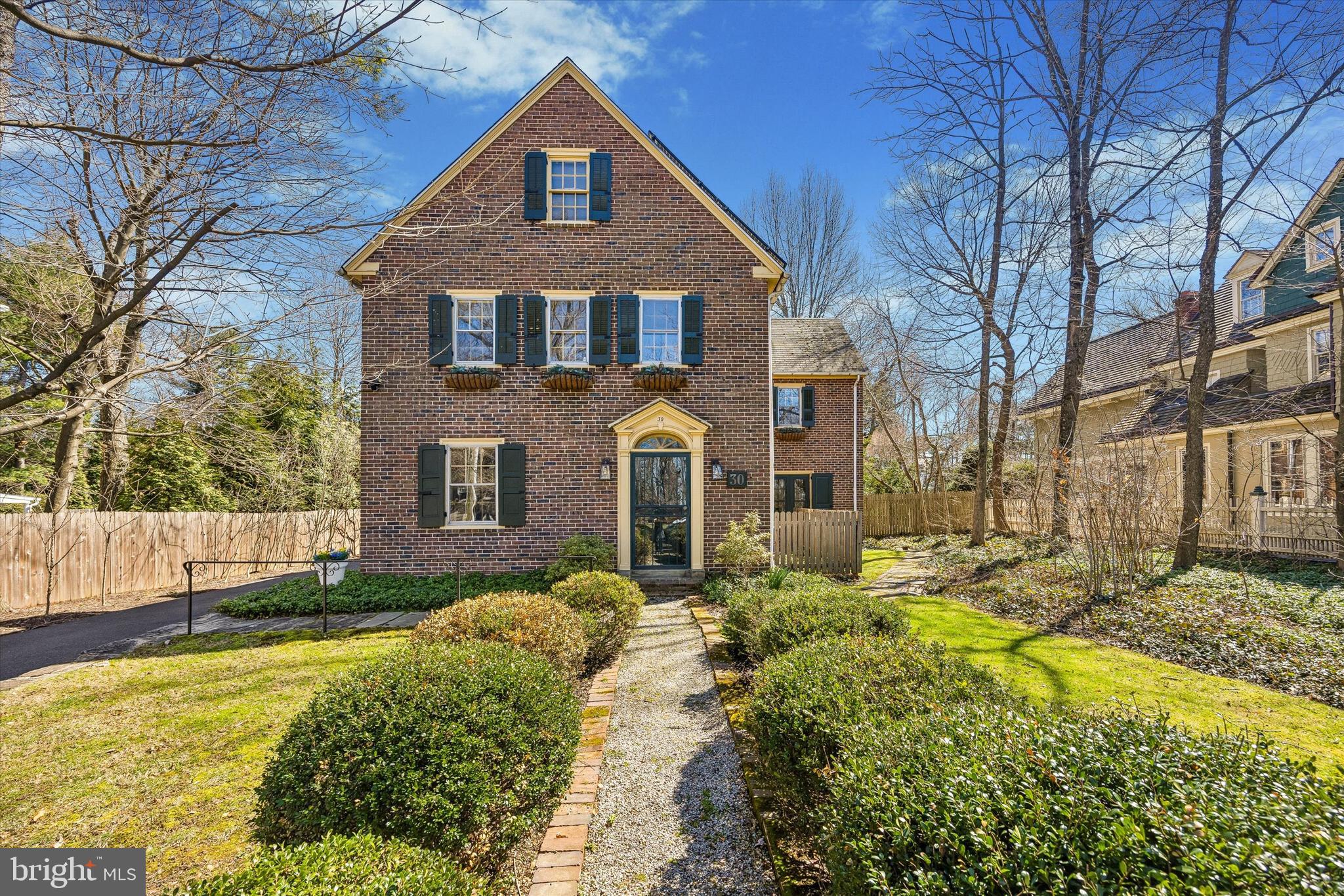 It’s rare to find this seamless blend of historic charm and modern comfort on one of Chestnut Hill’s most coveted “Top of the Hill” streets. Thoughtfully reimagined, this exceptional residence preserves its original architectural character while offering the updates today’s lifestyle demands. At the heart of the home is a recently renovated custom kitchen designed for gathering. Featuring stunning oak cabinetry, Café appliances, quartz countertops, elegant brass hardware, and a beautifully appointed bar area with wine and beverage refrigeration, the space is both warm and sophisticated.
The first floor offers a bright, flexible layout tailored to modern living. A gracious dining room lined with windows provides the perfect backdrop for entertaining. The inviting family room/den showcases a fireplace, built-in bookshelves, and direct access to the rear terrace. Just beyond, a pass-through library leads to an additional living space currently used as a living room—complete with a deep wood-burning fireplace and sliding glass doors opening to the terrace. A newly renovated laundry and mudroom with generous storage, cubbies, and a coat closet adds everyday convenience.
Upstairs, the second floor offers four to five bedrooms, depending on your needs. One room is currently styled as a sophisticated home office with custom built-ins and a desk, while another adjoins the primary suite and serves as a spacious dressing room. Three full bathrooms enhance the versatility and comfort of this level.
The third floor provides four additional bedrooms, including one currently used as a playroom/family lounge—ideal for guests, hobbies, or flexible living arrangements.
This stately brick home is rich with amenities, including central air, three-zone heating, refinished hardwood floors throughout, fully updated electrical (with all knob-and-tube wiring removed in 2019), a renovated first-floor powder room, and solar panels. A detached two-car garage sits just steps from the house and features a second-floor loft with a newly installed mini-split system for heating and cooling—offering endless potential for a studio, office, or guest space.
The private, fenced, professionally landscaped backyard is set on a rare, expansive flat lot with and includes a basketball court installed behind the garage. Multiple access points from the main level lead to the rear terrace, creating effortless indoor-outdoor living.
Located just steps from Germantown Avenue’s shops and restaurants, convenient to the R7 and R8 SEPTA rail lines, and within walking distance to the scenic trails of Wissahickon Valley Park, Morris Arboretum, and Woodmere Art Museum, this historically registered home offers the best of location, lifestyle, and legacy.