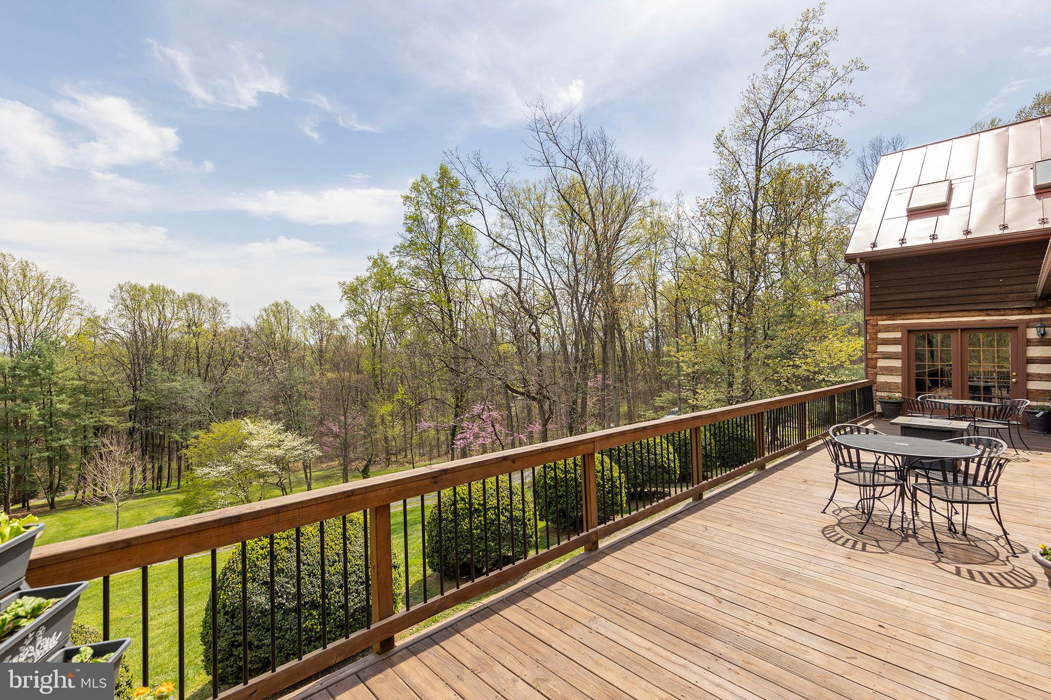 Escape to Your Private Retreat – Just 10 Minutes from Winchester!
Don’t miss the 3D tour attached to this listing!

Welcome to a truly one-of-a-kind property offering 27.65 secluded acres across three parcels, complete with towering trees, a tranquil pond, and breathtaking natural surroundings. This charming log home is rich with character and history—originally relocated here in the 1960s, with a thoughtfully designed three-story addition completed in 1994.  Step inside and be greeted by the warmth of exposed wood beams, a cozy fireplace, and the inviting feel of a classic cabin paired with modern comforts. The spacious kitchen, perfect for entertaining, features solid cherry cabinetry, quartz countertops, and an induction cooktop.
A true highlight is the sunroom, added in 2007—complete with radiant heated floors, a wood-paneled ceiling, and its own heating/cooling unit—where you can enjoy year-round views of your serene surroundings. Upstairs, the primary suite offers stunning views and a private ensuite bath. Two additional bedrooms and a convenient laundry room complete the upper level. Outdoors, you’ll love the expansive deck, perfect for gatherings or peaceful mornings. Enjoy seasonal blooms, mature plantings, and a wood stove for those crisp winter evenings. The walkout basement offers even more space with a mudroom, a large recreation room with fireplace, exposed beams, ample storage, and a mechanical room.

Recent Updates Include:

New A/C system (2024)

Kitchen refresh (2022)

Eco Water iron filter (2018; rebedded 2025)

Standing seam metal roof (2013)

Septic pumped (2024)

Electric fence to protect landscaping from deer

Located just off Routes 37 and 50, this unique property delivers the perfect balance of privacy and accessibility.
septic <#BR

Three included parcels:

6.15 acres – Tax ID: 61-A-70

10.50 acres – Tax ID: 61-A-63

11.00 acres – Tax ID: 61-A-65

Great property for multi-generational setup or future resale strategy. There is an opportunity to divide the parcel and create a separate driveway access, subject to county subdivision regulations, zoning etc.. confirm with the county and engineer during your due diligence. Schedule your private showing today—this one is truly a rare gem. Check out the 3-D tour attached to this listing!
