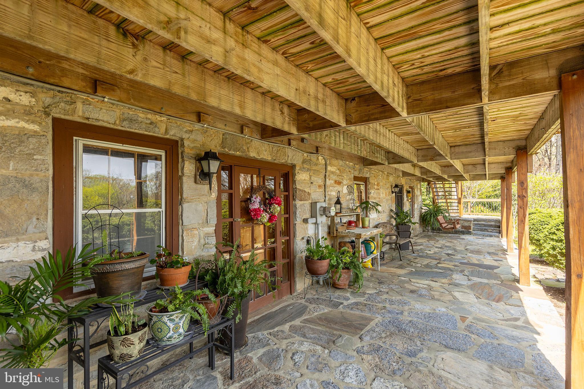 Escape to Your Private Retreat – Just 10 Minutes from Winchester!
Don’t miss the 3D tour attached to this listing!

Welcome to a truly one-of-a-kind property offering 27.65 secluded acres across three parcels, complete with towering trees, a tranquil pond, and breathtaking natural surroundings. This charming log home is rich with character and history—originally relocated here in the 1960s, with a thoughtfully designed three-story addition completed in 1994.  Step inside and be greeted by the warmth of exposed wood beams, a cozy fireplace, and the inviting feel of a classic cabin paired with modern comforts. The spacious kitchen, perfect for entertaining, features solid cherry cabinetry, quartz countertops, and an induction cooktop.
A true highlight is the sunroom, added in 2007—complete with radiant heated floors, a wood-paneled ceiling, and its own heating/cooling unit—where you can enjoy year-round views of your serene surroundings. Upstairs, the primary suite offers stunning views and a private ensuite bath. Two additional bedrooms and a convenient laundry room complete the upper level. Outdoors, you’ll love the expansive deck, perfect for gatherings or peaceful mornings. Enjoy seasonal blooms, mature plantings, and a wood stove for those crisp winter evenings. The walkout basement offers even more space with a mudroom, a large recreation room with fireplace, exposed beams, ample storage, and a mechanical room.

Recent Updates Include:

New A/C system (2024)

Kitchen refresh (2022)

Eco Water iron filter (2018; rebedded 2025)

Standing seam metal roof (2013)

Septic pumped (2024)

Electric fence to protect landscaping from deer

Located just off Routes 37 and 50, this unique property delivers the perfect balance of privacy and accessibility.
septic <#BR

Three included parcels:

6.15 acres – Tax ID: 61-A-70

10.50 acres – Tax ID: 61-A-63

11.00 acres – Tax ID: 61-A-65

Great property for multi-generational setup or future resale strategy. There is an opportunity to divide the parcel and create a separate driveway access, subject to county subdivision regulations, zoning etc.. confirm with the county and engineer during your due diligence. Schedule your private showing today—this one is truly a rare gem. Check out the 3-D tour attached to this listing!