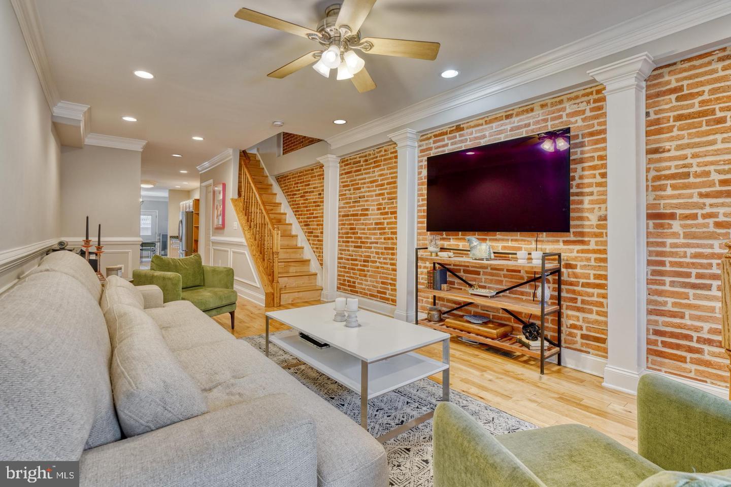 Welcome to a meticulously maintained gem in Federal Hill! This captivating residence spans four well-appointed levels, offering the epitome of city living with the luxury of private parking and a stunning rooftop deck. As you step inside, you'll be greeted by a spacious and inviting open concept on the first floor. Gleaming wood floors, recessed lighting, and exposed brick add a touch of charm to the space. Enjoy the distinction of separate living and dining areas, complemented by a convenient powder room. The expansive kitchen features stainless steel appliances, granite countertops, and an abundance of cabinet space. Adjacent is a delightful breakfast room that opens up to a rear parking pad, providing ultimate convenience. The second level comprises two generously-sized bedrooms, both featuring ample closet space, accompanied by two full bathrooms and a dedicated laundry room. Ascend to the third level, where a wet bar awaits, providing the ideal setting for entertaining guests before stepping out to the enchanting rooftop deck. The lower level offers versatility with options for a third bedroom, a home office, or a family room, complete with its own full bathroom. Located in one of Baltimore's most sought-after neighborhoods, you'll enjoy easy access to the downtown business district, Inner Harbor, restaurants, shops, and entertainment options that define Federal Hill living.