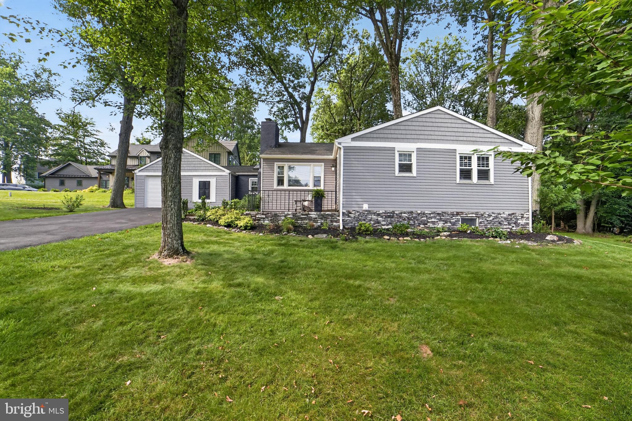 Home isn’t just a place—it’s a feeling.  Welcome to this beautifully renovated 4-bedroom, 3 full bathroom ranch home with a one-car garage, thoughtfully updated with exceptional attention to detail. Ideally located less than a 4-minute walk to Conestoga High School—ranked #2 in Pennsylvania by Niche and among the top schools in the state by U.S. News & World Report—this home offers both luxury and convenience in one of the Main Line’s most desirable neighborhoods.
   Step inside to a welcoming entry hall that opens to a sun-filled living room featuring refinished hardwood floors, recessed lighting, and a charming wood-burning fireplace. The spacious dining room flows seamlessly from the living area, creating an ideal layout for everyday living, entertaining, and fine dining.
The heart of the home is the expansive, enlarged eat-in kitchen, designed to impress. Highlights include a skylight, quartz countertops, marble backsplash, abundant 42-inch white shaker cabinetry, a pantry closet, coffee bar, recessed lighting, and stainless-steel appliances, including a convection/conduction cooktop. The kitchen opens directly to a large stone paver patio with black aluminum fencing, offering peaceful nature views and the perfect indoor-outdoor lifestyle.
    Three sun-filled bedrooms feature plantation shutters, refinished hardwood floors, and recessed lighting, along with an enhanced primary bedroom closet. The enlarged primary bathroom boasts an oversized seamless glass stall shower with bench seating, a contemporary vanity, and designer tile throughout. A beautifully updated hall bathroom includes a soaking tub, designer tile, recessed lighting, and a convenient stackable washer and dryer.
   The lower level significantly expands your living space with a fully finished basement designed for flexibility and comfort. Featuring durable polyaspartic-coated flooring, recessed lighting, and abundant electrical outlets, this level is ideal for entertaining, recreation, or extended living. A remodeled full bathroom includes a tub, sink, and new vanity. The fourth bedroom offers recessed lighting, newer carpet, and a large, refinished closet. A separate, remodeled laundry room with recessed lighting and a full-size washer and dryer provides added convenience. The expansive layout offers endless possibilities—whether you envision a media room, home gym, in-law suite, or private guest quarters.
   Set on an impressive 0.68-acre lot, the property offers a partially fenced yard with elegant black aluminum fencing, a stunning stone paver patio, and a dedicated barbecue area that flows into a white stone fire pit space. Surrounded by mature oak, maple, and walnut trees, the setting is serene and private, with birdsong providing a tranquil backdrop.
   Enjoy close proximity to local favorites including Whole Foods Market, Handel’s Homemade Ice Cream, and Autograph Brasserie. Nearby attractions such as the Devon Horse Show and Country Fair, Jenkins Arboretum & Gardens, Wilson Farm Park, and Westover Bird Sanctuary provide endless opportunities for outdoor enjoyment.  Commuters will appreciate easy access to Berwyn Station for direct service to Center City, as well as proximity to King of Prussia Mall and IMAX theaters.
This home seamlessly blends modern living, natural beauty, and an unbeatable location—offering a lifestyle that is as comfortable as it is connected.