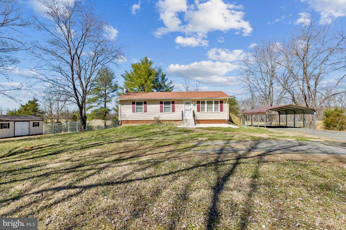 Welcome Home!  Peaceful and serene.  Enjoy nature sitting on the front patio or rear deck.  This home just needs a little TLC to make it your own.  Detached carport offers protection from the sun and snow.  Fenced rear yard is great for letting your dog run free.  Spacious shed for storing the lawn mower and gardening tools.   Hardwood floors in living room and both bedrooms.  Ceramic tile in kitchen, bathrooms and the basement.   Basement offers a rec room with bar, a den/study and the laundry.  Washer and dryer convey As-Is.  There are multiple sources of heat and AC.  A heat pump with a Nest thermostat, baseboard heat, each room has its own control, a pellet stove that conveys and a split unit in the basement.  Offer deadline is Saturday March 22nd @ 5:00 pm.