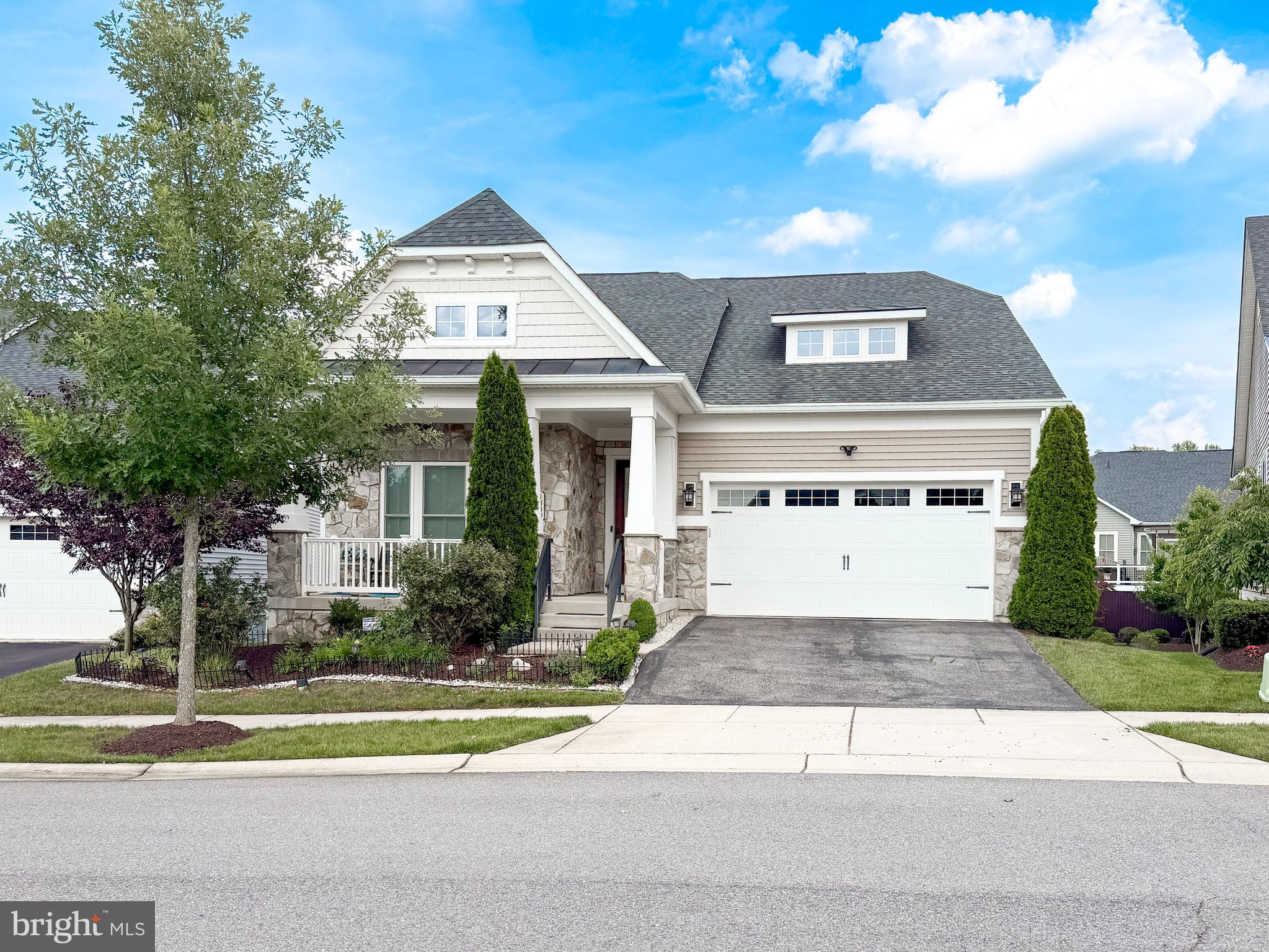 Welcome to 1339 Chicory Way, a sought-after 55+ community in north Odenton! Gleaming, solid hardwood floors and tray ceiling greet you upon entry. Solid hardwood continues throughout the main floor, which includes twelve-foot ceilings and elegant crown molding in each room. This home offers a primary bedroom suite and two additional, generously sized bedrooms on the main floor. A formal dining room with wainscotting seamlessly flows into the living room, boasting an electric-powered fireplace with upgraded marble hearth. 
Cook gourmet meals while entertaining guests in the adjacent kitchen with an oversized island and granite countertops. A bump-out breakfast nook leads to a large, private, enclosed deck/balcony and open deck are where you may enjoy morning coffee and host backyard barbecues. Retreat to the private oasis of your master/primary suite adjacent to the living area, featuring a master bath with double basin sinks, Roman shower, a water closet, linen closet and huge walk-in closet. 
The finished basement features wall-to-wall carpeting, French doors, leading to an office/den/library, and a spacious entertaining area with another French door, leading to a patio underneath the deck. The enormous, unfinished basement area includes plumbing rough-in for a future third bathroom; if you choose to finish that area, you'll have approximately 1000 sq. ft. of total, basement living space!
Yardwork chores will never burden you here because your HOA dues in this managed community includes complete lawn maintenance. It also affords you access to your exclusive, 55+ clubhouse, tennis courts, walking trails through the neighborhood, and a separate, 55+ swimming pool. 
Make 1339 Chicory Way your new home and enjoy an Epicurean lifestyle that all these amenities will offer you!