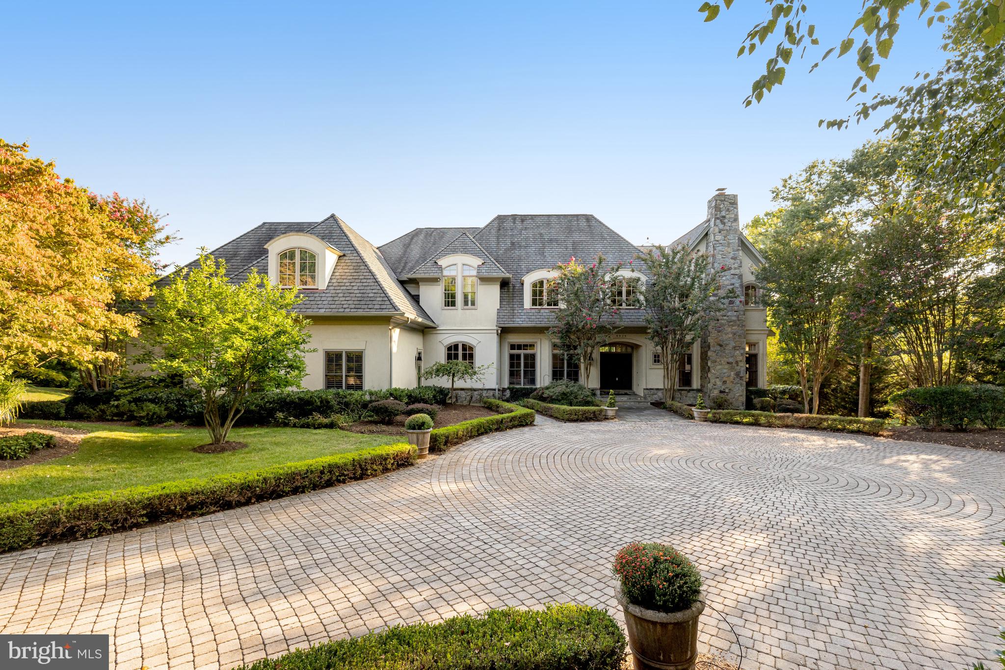 Great New Price! Custom-Quality Winthrop home with gorgeous heated pool located at the end of a quiet cul-de-sac (set well back from the activity of Georgetown Pike), perfectly sited on a private 5-acre lot. Serene setting, surrounded by trees and mature, professionally-maintained landscaping and extensive hardscaping - offering incredible views and privacy, in a convenient location - just minutes to 495, Tysons and downtown McLean. This impressive home, with 4 bedrooms, 4 full and 3 half baths and over 7,000 sq ft of living space, offers all the conveniences of how we live today. The main level feels open and airy, with high ceilings, gorgeous trim detail, hardwood floors throughout and an abundance of oversized windows. The thoughtful layout provides options for work-from-home lifestyles. Featuring a private home office with built-ins and direct access to the slate patio with steps down to the pool deck, a living room with fireplace, separate dining room and cozy family room with an oversized stone fireplace, and floor-to-ceiling windows on both sides offering direct access to the patio. The large eat-in kitchen has an incredible amount of storage and counter space with a large center island, as well as back stair access to the upper level, a large laundry room and additional main level ½ bath off the 3-car side-load garage. 

The upper level, with hardwoods throughout, has four generously-sized ensuite bedrooms, including the light-filled primary bedroom suite, with spectacular views of the property and a fireplace.  The primary bathroom has a separate walk-in steam shower and soaking tub, radiant heated floors, and a cedar closet. A large addition, added in 2005, with large sitting area, built-ins and a fireplace, offers multiple options for use as an alternate primary bedroom, 5th bedroom, home office, playroom, exercise room, study, craft room.... 

The finished lower level offers a large and comfortable rec room with fireplace and French doors with access to the slate patio, a wet bar, a home gym/yoga studio with a mirrored wall and sauna, a gorgeous wine room and plenty of storage space. 

Langley High School pyramid, immediate access to major commuter routes, minutes to high-end shopping, everyday conveniences, a variety of grocery stores and dining experiences, as well as parks and exercise facilities.