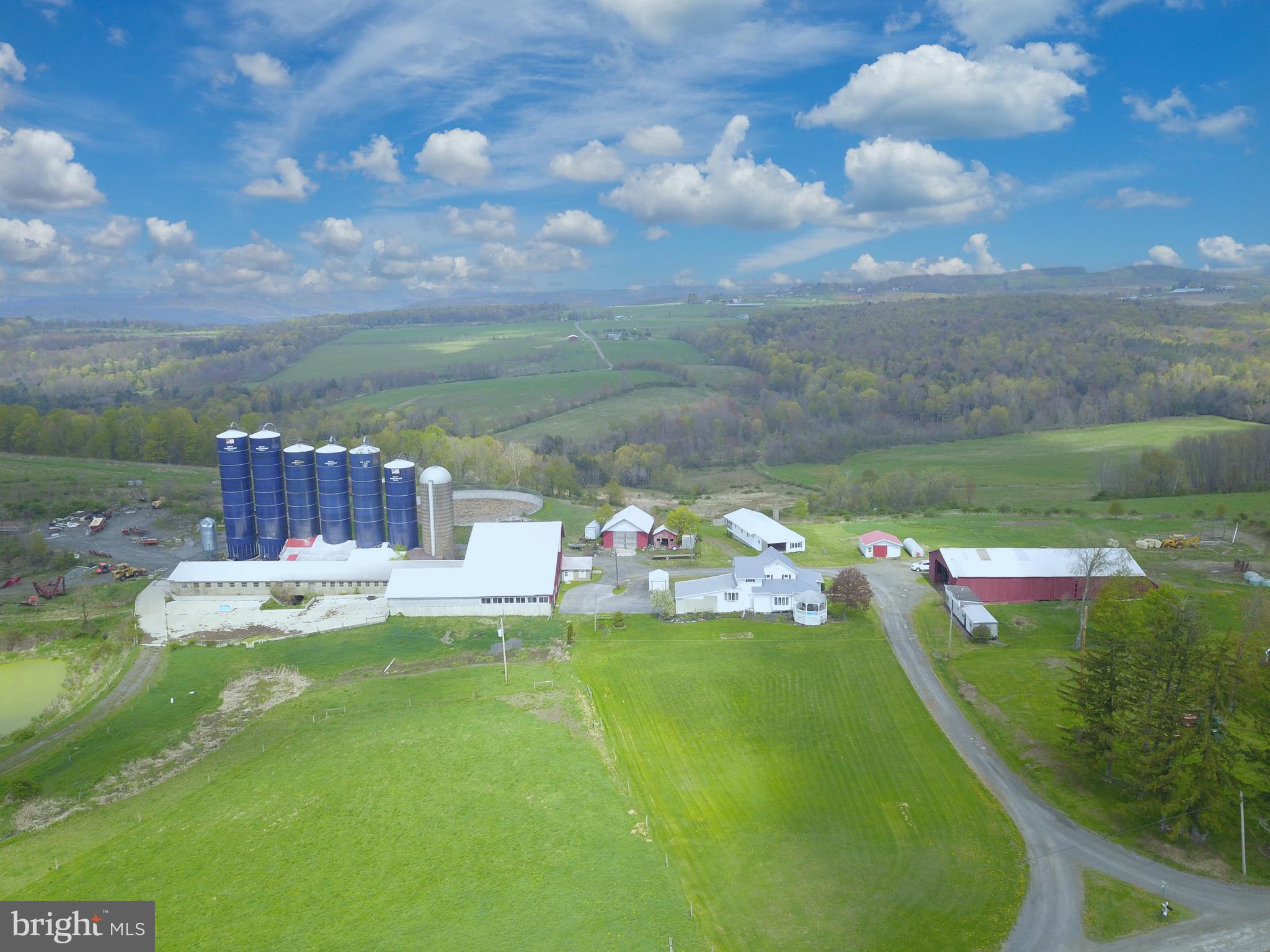 641 + Acre Certified Organic Farm with approx. 300+ tillable acres, pasture, approx. 300+ woodland,  4 bedroom house, 3- bedroom mobile home with garage, double 10 milking parlor, loafing area, hay and feed storage, 50'x100' hay & equipment storage building, 22'x22' detached shed/garage, 30'x40' shop, 36'x235 (112) tie cow barn, (1) 20'x70' staved silo, (3) 20'x80' & (2) 20'x90' Harvestore silos, 56' dia. x 16' deep manure pit. Tillable land is semi level, some timber value, property is approx. 5 min from town. OMG's reserved but can be purchased.