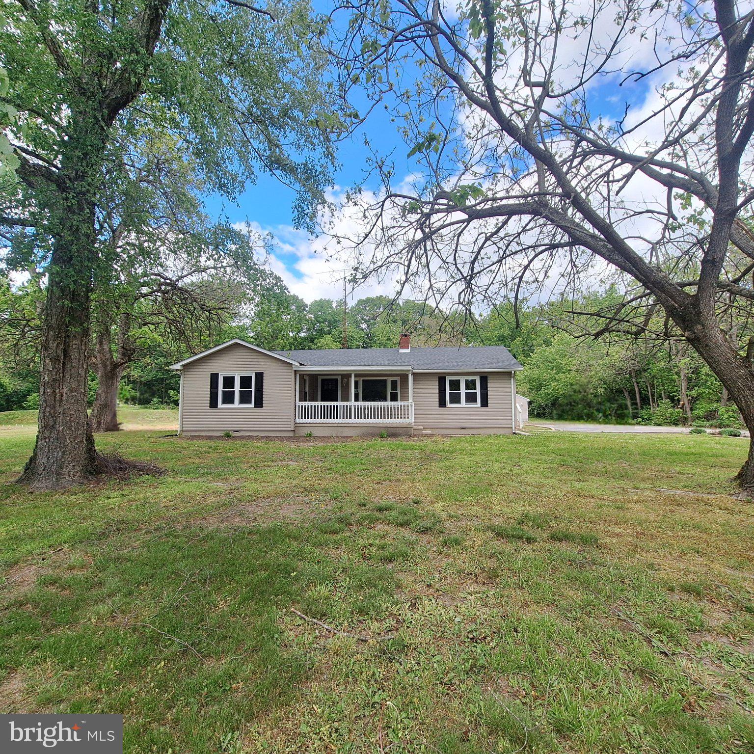 Welcome to this beautiful one floor living ranch home, perfectly blending modern updates with classic comfort. Featuring 4 spacious bedrooms and 2 full bathrooms, this charming home sits on over 1.5 acres of peaceful land—ideal for anyone seeking space, privacy, and the warmth of country living with the convenience of nearby amenities. The welcoming covered front porch sets the tone for this inviting property, offering a cozy spot to relax with a cup of coffee or hot tea on a beautiful spring morning. Step inside to find a bright and open living room with brand-new luxury vinyl plank flooring, fresh paint, and plush new carpet throughout. The large living area centers around a beautiful wood-burning fireplace—perfect for gathering with friends and family on chilly evenings. The heart of the home is the kitchen, featuring recessed lighting, stainless steel appliances, abundant counterspace, and a convenient pantry for storage. The open layout easily accommodates an eat-in dining space, making it ideal for everyday meals or entertaining guests. Just off the kitchen area, a spacious room provides incredible versatility—use this space as a 4th bedroom with it’s own full bathroom or use it as a family room or create your own home theater, a quiet office, a playroom, or a hobby space. With plenty of natural light and room to spread out, this is a space that can truly adapt to your lifestyle. Outdoors, the possibilities are endless. The expansive yard offers ample room for a flower or vegetable garden, an inviting fire pit area for roasting marshmallows under the stars, or space to host weekend barbecues and outdoor gatherings. The oversized one-car garage and wide driveway offers plenty of parking for large vehicles, boats, or recreational vehicles. Additional highlights include a brand new septic (2026) new roof (2018), new heater (2019), new well (2024), and main-floor laundry for ultimate convenience. Perfectly located just a few miles from Route 13, this property provides easy access to shopping centers, grocery stores, restaurants, schools and fitness facilities while maintaining a quiet, private setting. Don’t miss your chance to make this beautiful, renovated home your own—schedule your showing today!