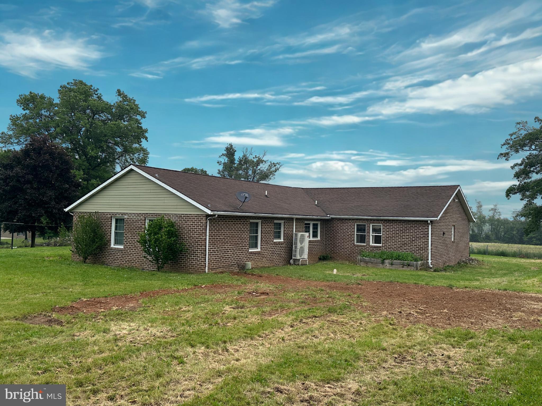 Solid Bones, Real Space, and Room to Make It Yours.
Brick ranchers don't come along often — and this 1988 all-brick home on 2.03 open acres in Franklin County delivers the kind of square footage and durability that's genuinely hard to find at this price. With over 2,500 finished square feet on one level plus a full basement, there's real room to live, work, and spread out.
The standout is the 19x28 kitchen — anchored by a large island, custom raised-panel cabinetry, double oven, propane cooktop, and recessed lighting. There's plenty of space to add appliances and make it entirely your own. The living room features a quality wood stove and wood wainscoting, creating a warm, inviting gathering space.
Major systems have been addressed: a 2021 Mitsubishi heat pump provides both heating and central air, 14 replacement windows were installed that same year, and a whole-house re-plumb was completed in 2025. The 33x8 covered front porch overlooks a fully chain-link fenced lot — practical for your pets, or simply enjoying the open countryside.
This property is priced for buyers who recognize value and are ready to add their own finishing touches. Conventional and cash financing. Schedule your private tour today.
