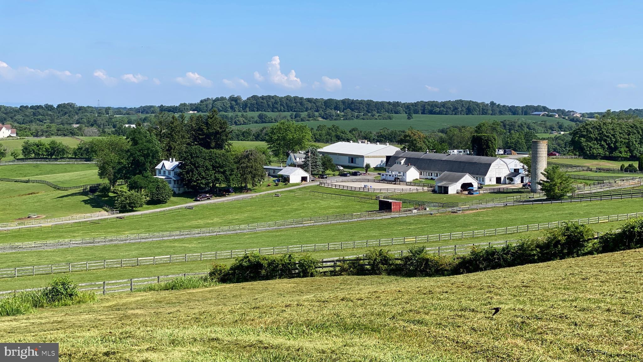 The clients and workers of the boarding business all would like to stay if given the opportunity. The facility consists of 50 stalls on 58.77 acres. The "lower barn" is a 32 stall center aisle barn with an adjoining building that has a heated tack room with lockers, a bathroom for clients and a wash stall. Above this barn is a 4 bedroom apartment and a one bedroom apartment both of which are currently occupied by farm employees. The "upper barn" is a center aisle barn with 18 stalls, a heated tack room and wash stall. There is a 160 x 80 indoor ring with lights and a watering system. There are 2 outdoor rings! The larger of the two outdoor rings is 225 x 120. The smaller outdoor is 80 x 60. The lights on the farm have been replaced with high efficiency LEDs. There is direct access to trails from the farm! In addition to the two apartments there are 2 detached homes on the property. One home is a traditional farmhouse style with a large welcoming front porch, eat-in kitchen, living room, dining room, 2 bedrooms on the main level and 3 bedrooms upstairs. The second home is a brick cape cod. This home has a living room, dining room, country kitchen, 2 bedrooms on the main level and 2 bedrooms upstairs. The huge loft above the "lower barn" would be an amazing venue and the multiple homes/apartments could be used as B&Bs. The farm is centrally located for many equestrian disciplines with access to Rtes 270 and 70. The total acreage is a combination of 3 parcels totaling 58.77 acres. In the documents section is an aerial picture that shows the outline of each pasture, the fence line and all the buildings.  This property is listed as MDMC2088400 and MDMC2088394. The property is also known as 11415 Bethesda Church Road.